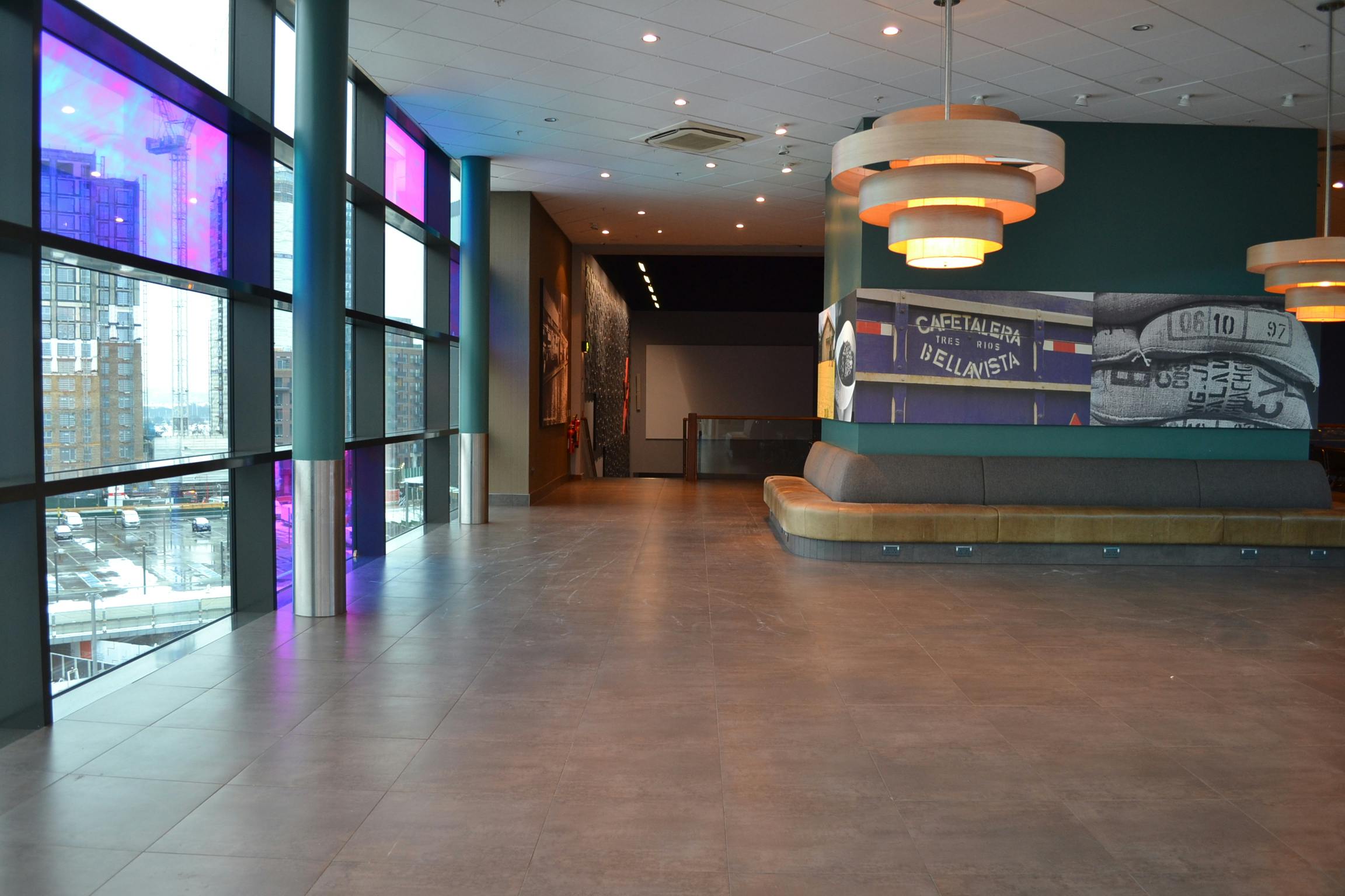 Modern reception space with large windows at Cineworld Wembley for events and gatherings.