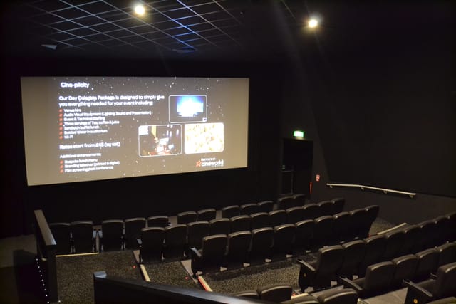Modern event space in Cineworld Wembley with large screen and tiered seating for presentations.