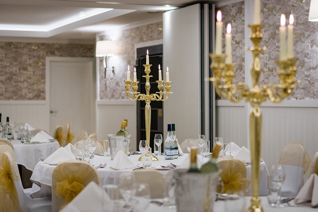 Elegant dining table with gold candelabra at Bristol Harbour Hotel for formal events.