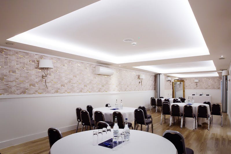 Meeting room at Bristol Harbour Hotel with round tables for corporate events.