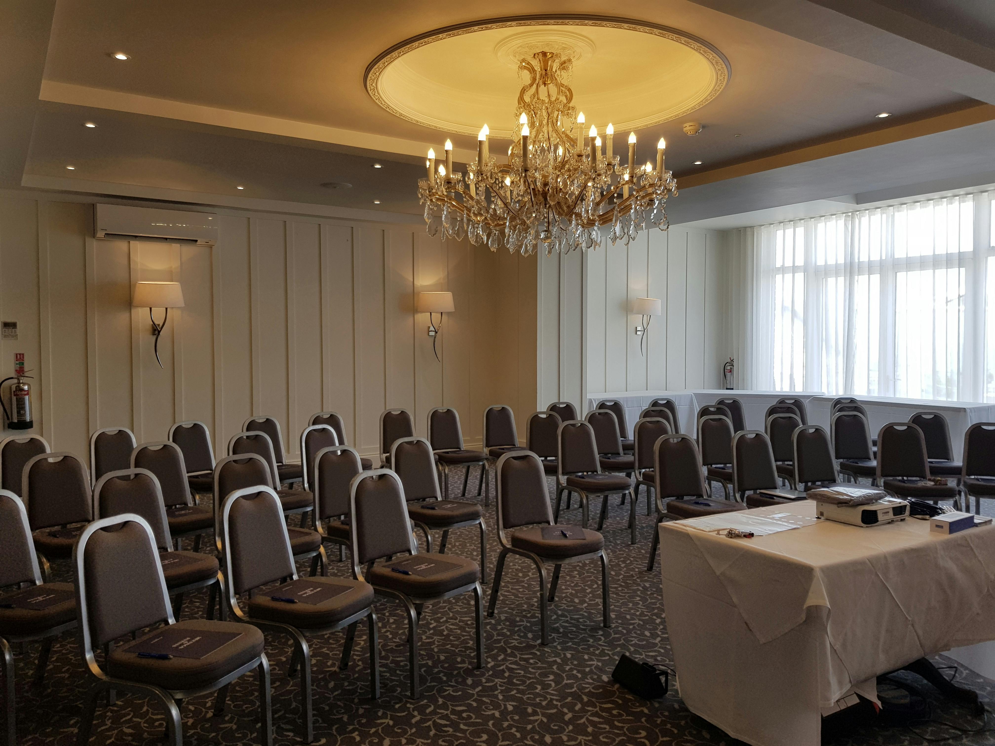 Connaught Suite at Sidmouth Harbour Hotel, elegant chandelier, corporate event venue.