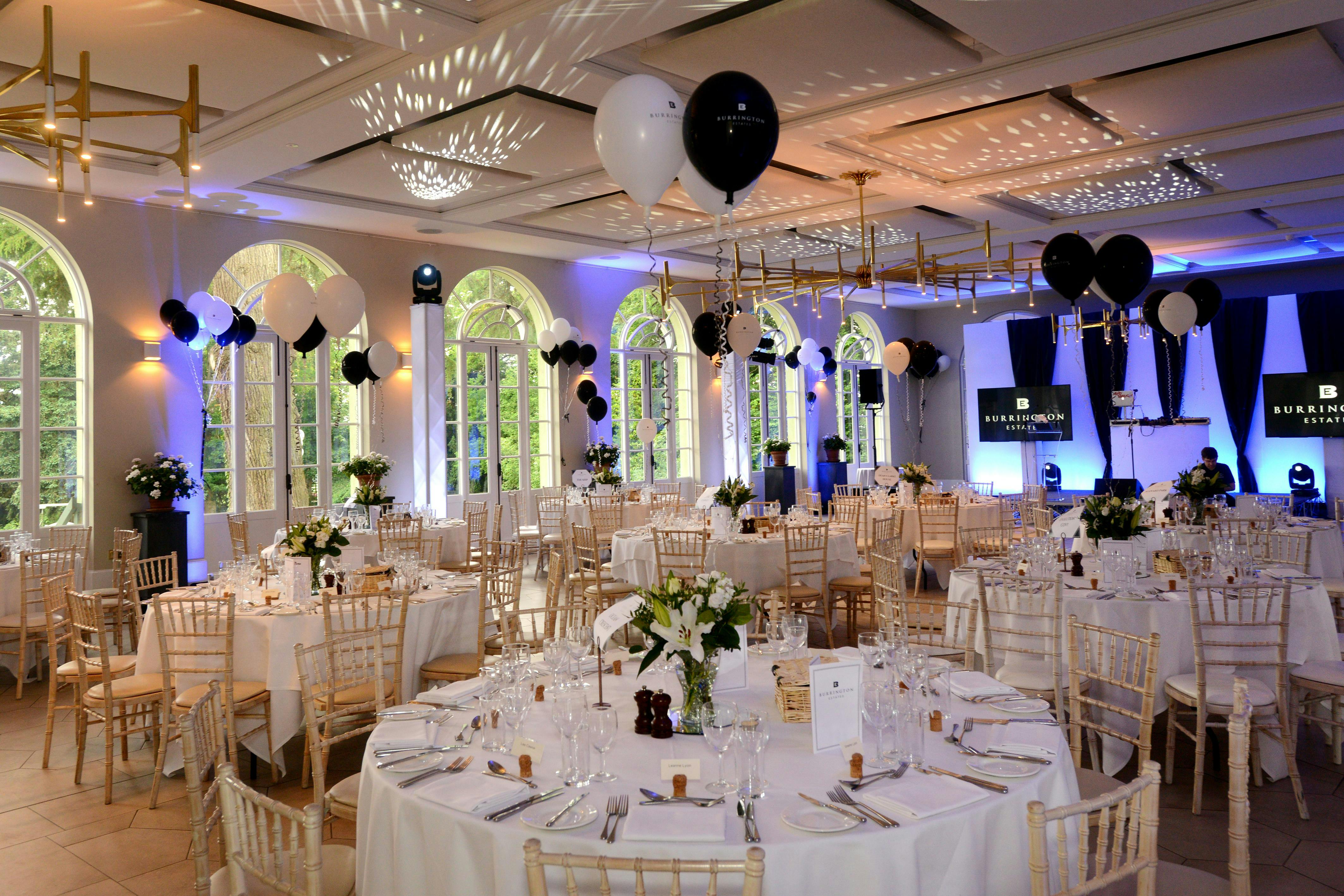 Elegant event space with round tables, ideal for weddings and corporate gatherings.