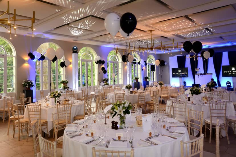 Elegant event space with round tables, ideal for weddings and corporate gatherings.
