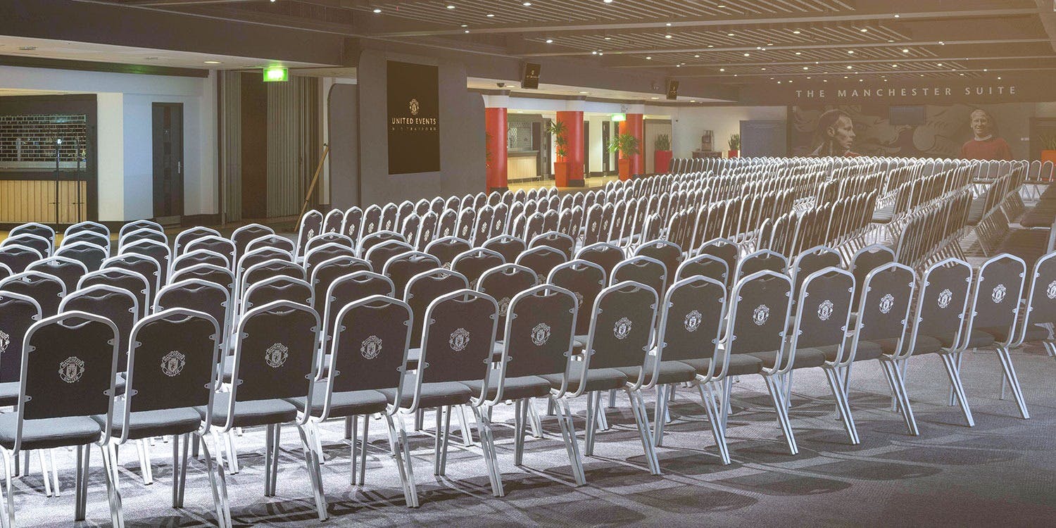 Conference event space at Old Trafford, Manchester; organized seating for corporate meetings.