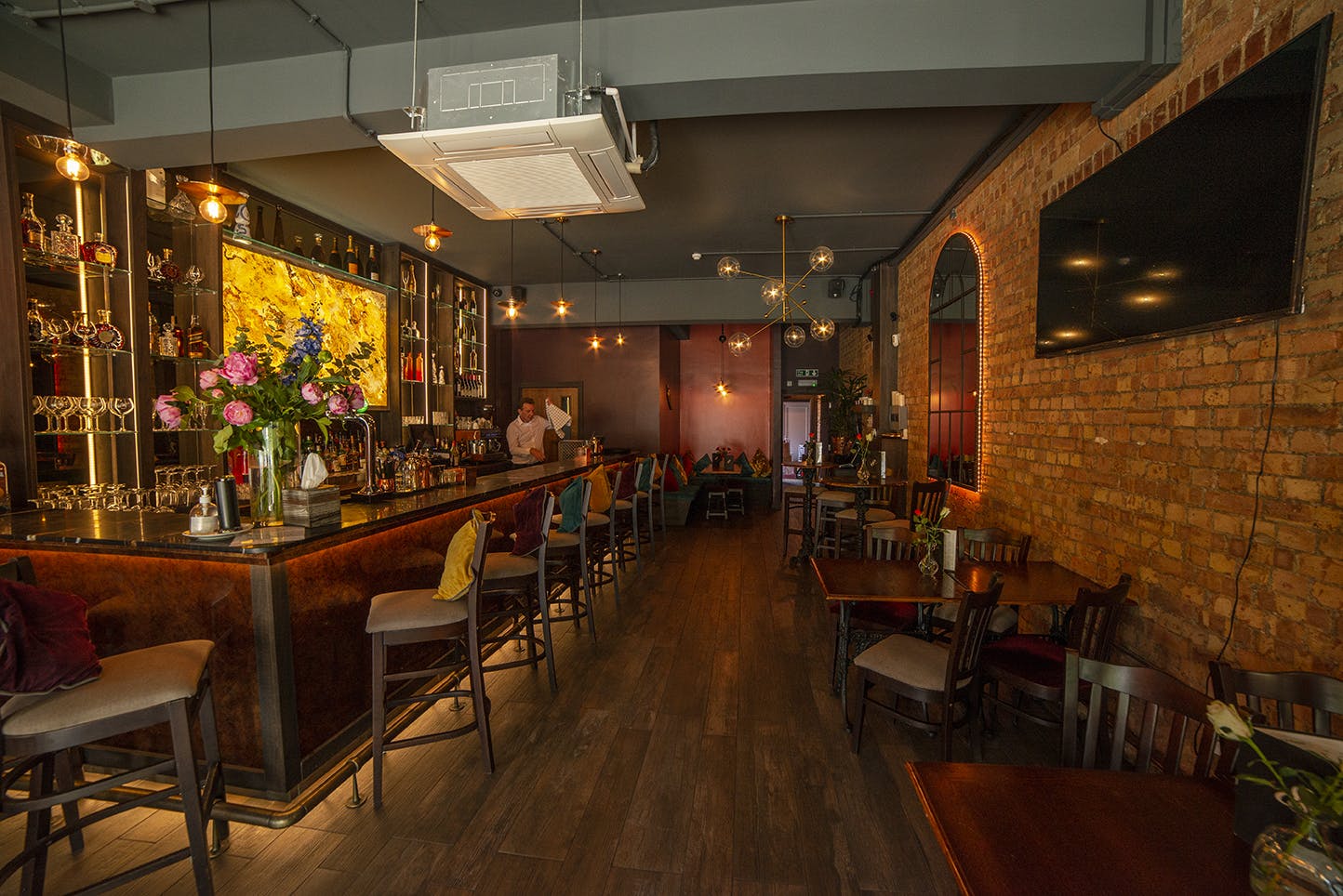 Stylish BAR 8 venue with exposed brick, perfect for networking and celebrations.