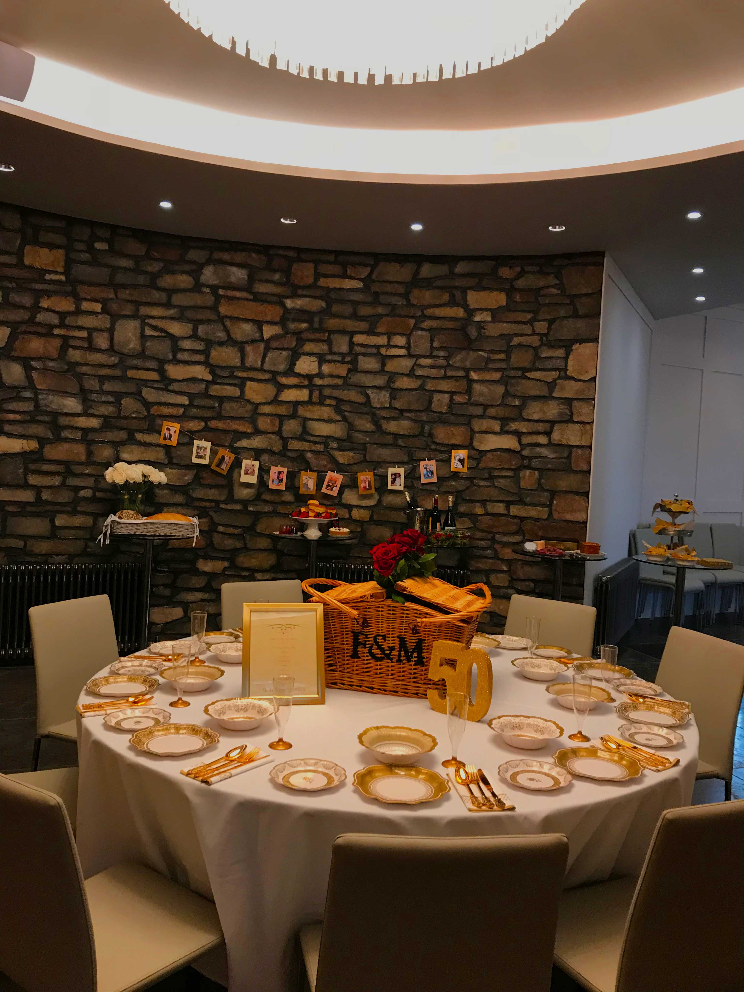 Elegant round table with flower centerpiece at Clifton Observatory for milestone celebrations. - Banner