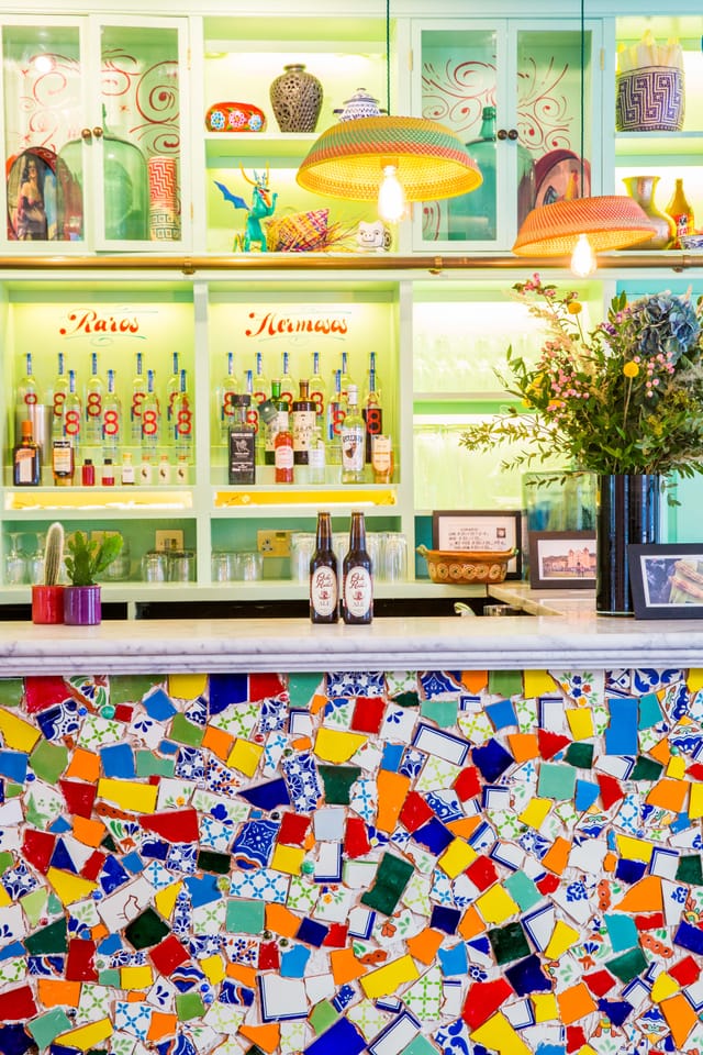 Agave dining room bar with colorful bottles, ideal for events and gatherings.