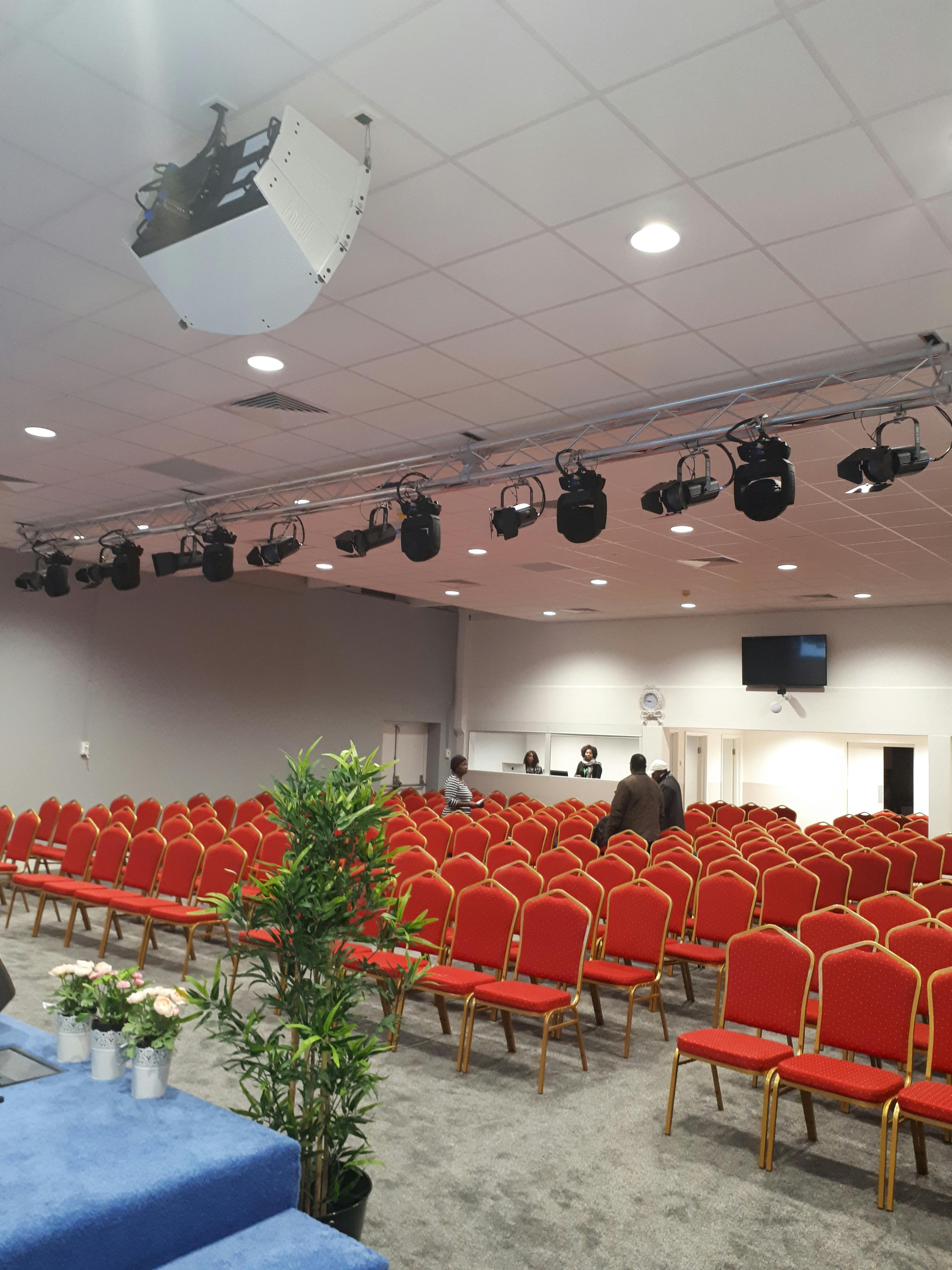 Business conference room with red chairs, ideal for seminars and presentations.