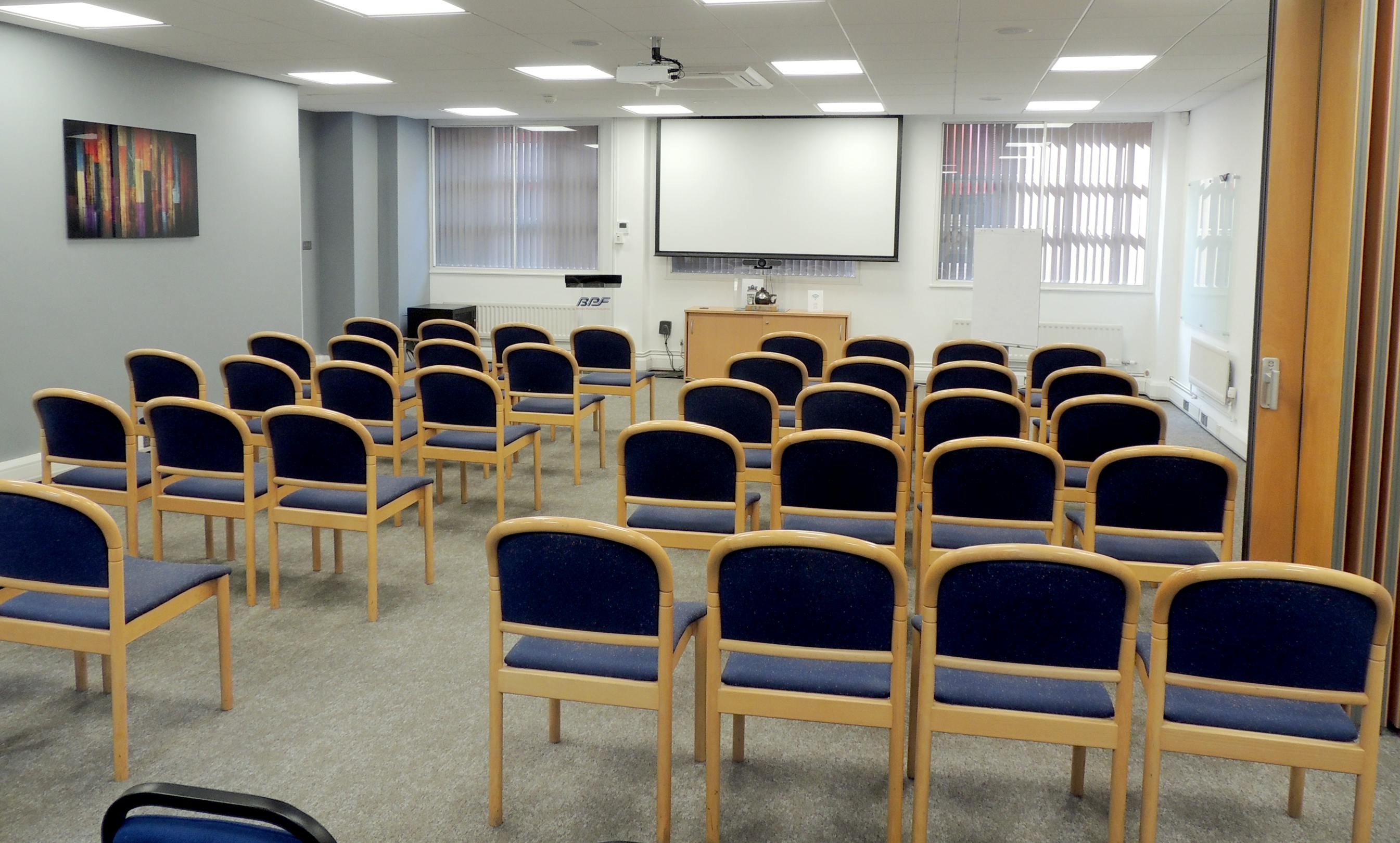 Meeting room for 50 with organized seating, ideal for seminars and presentations.