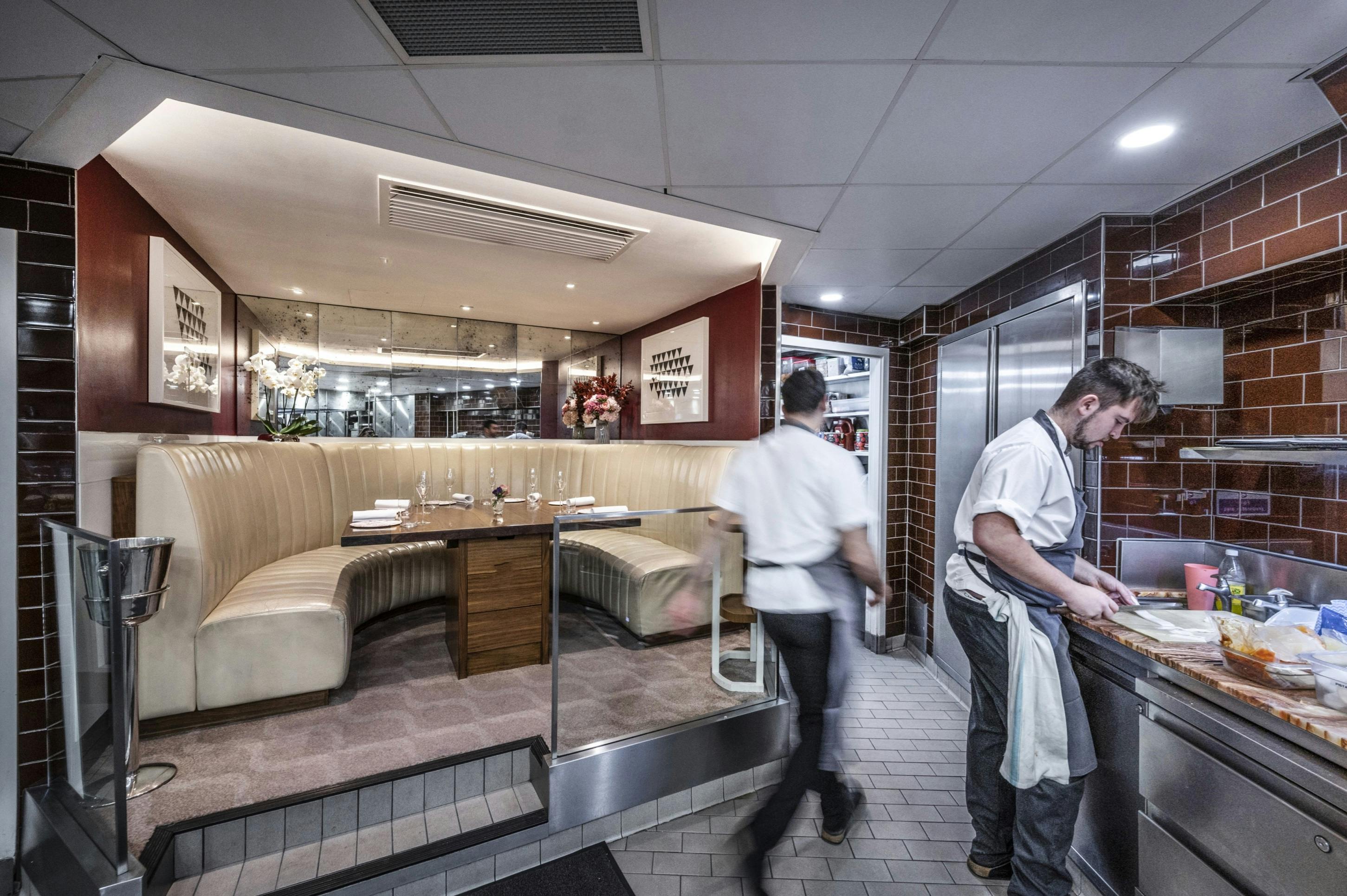 Cozy kitchen table in Petrus restaurant, ideal for intimate meetings and small events.