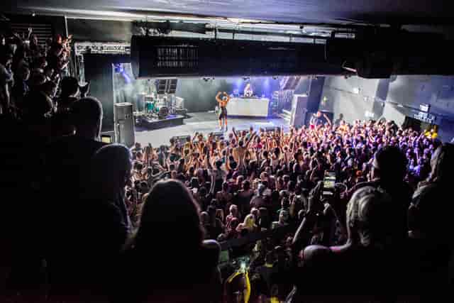Vibrant live event in Tramshed Cardiff with engaged audience and dynamic stage setup.