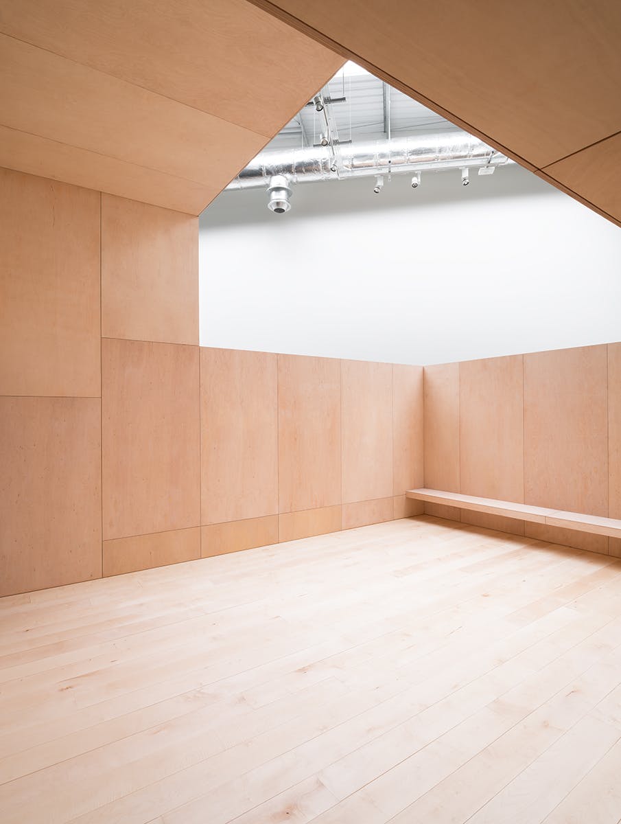 Obsidian Terrace: minimalist meeting space with wooden paneling for workshops and gatherings.