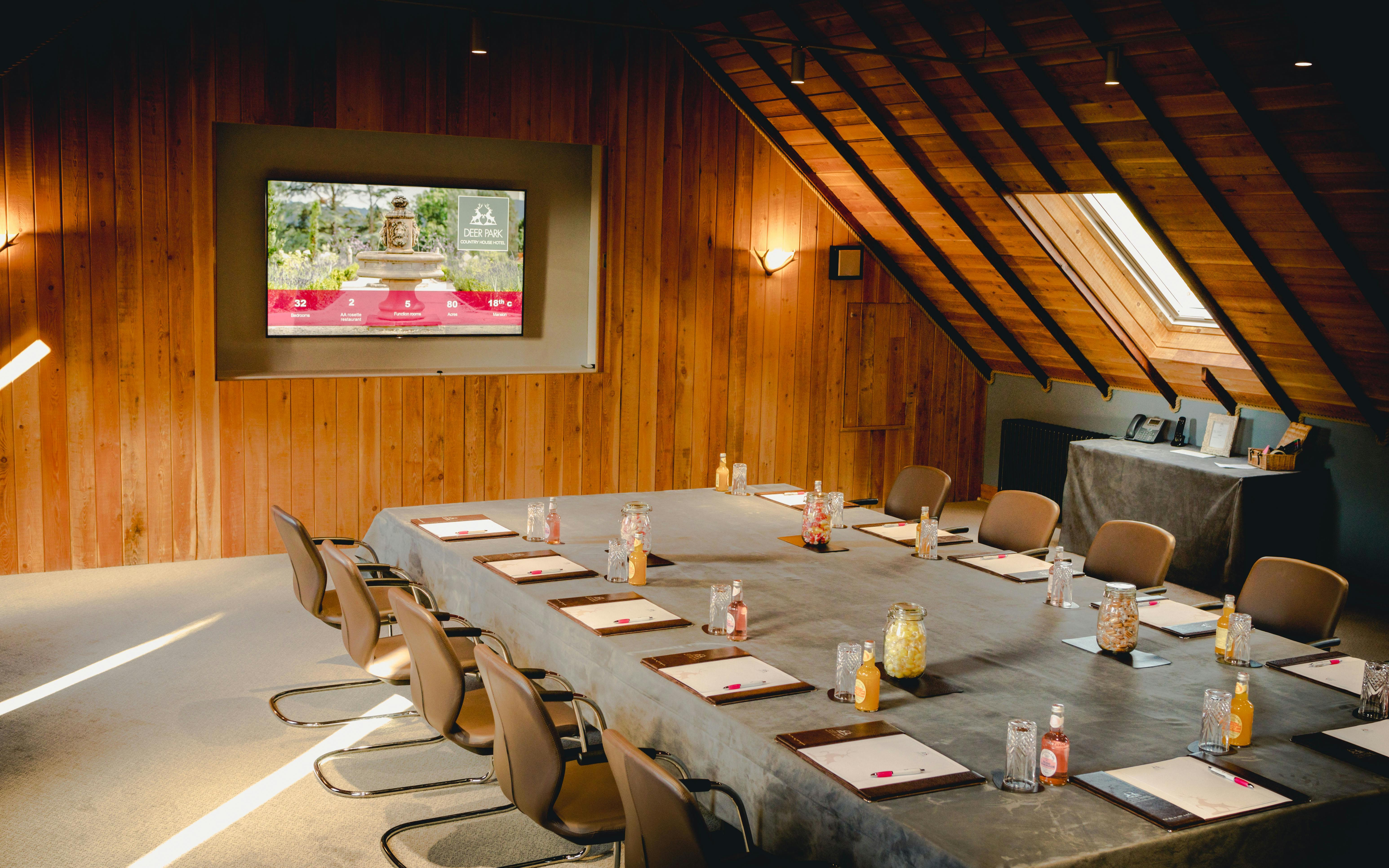 Motor House Meeting Room with long table, ideal for professional gatherings and events.