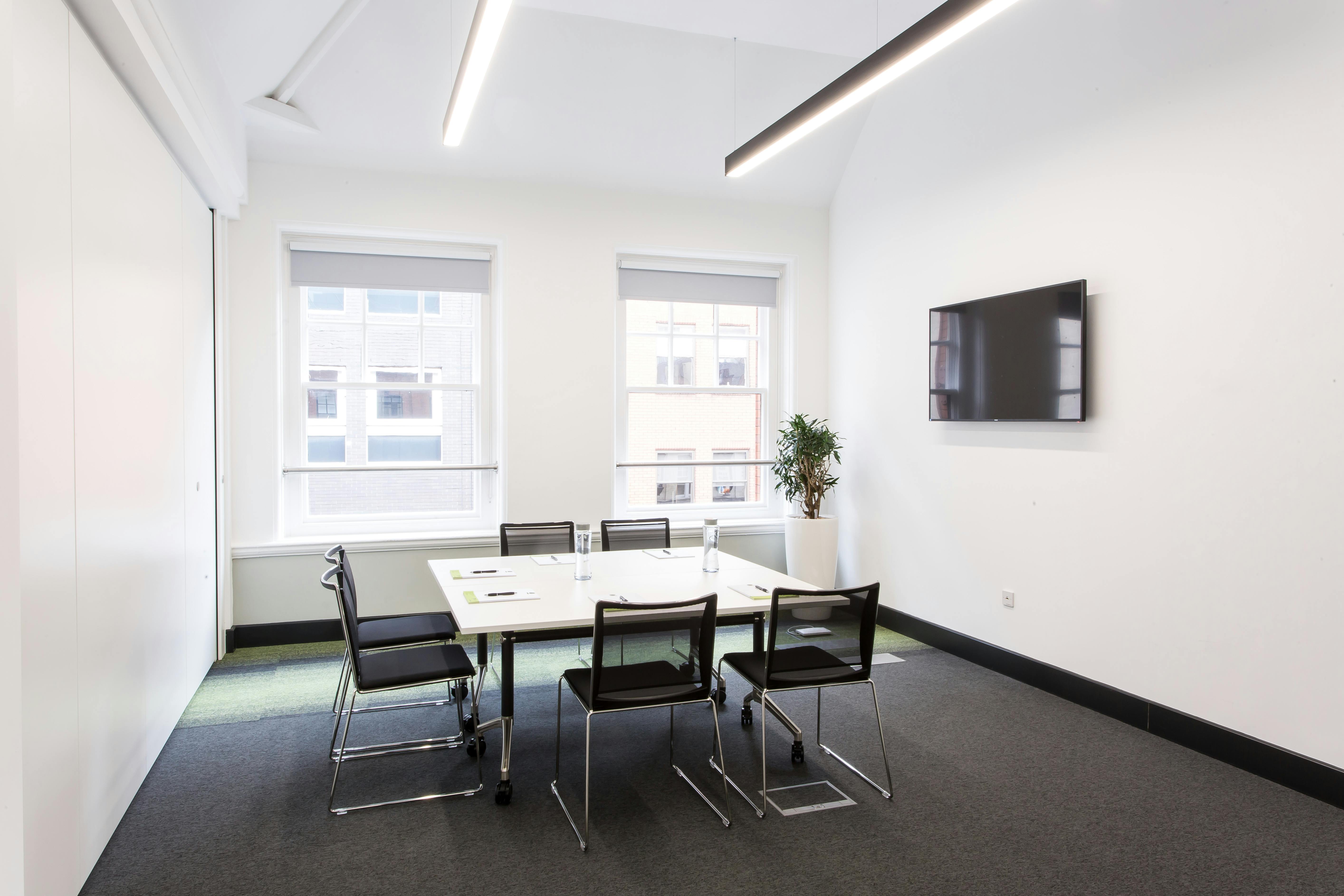 Modern meeting room Gaskell Room A with large windows, ideal for presentations and collaboration.