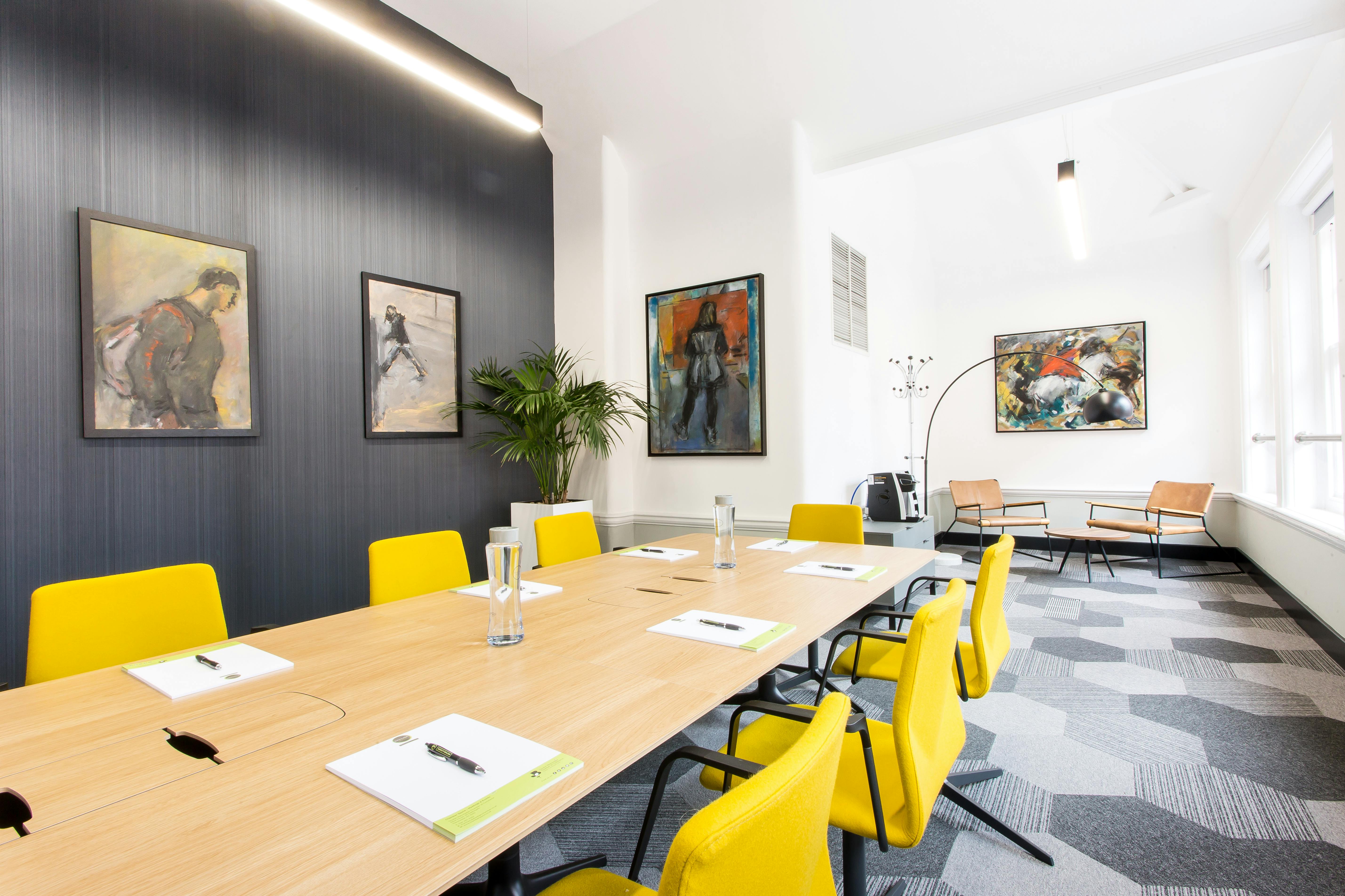 Modern Executive Boardroom with yellow chairs for creative meetings and events.