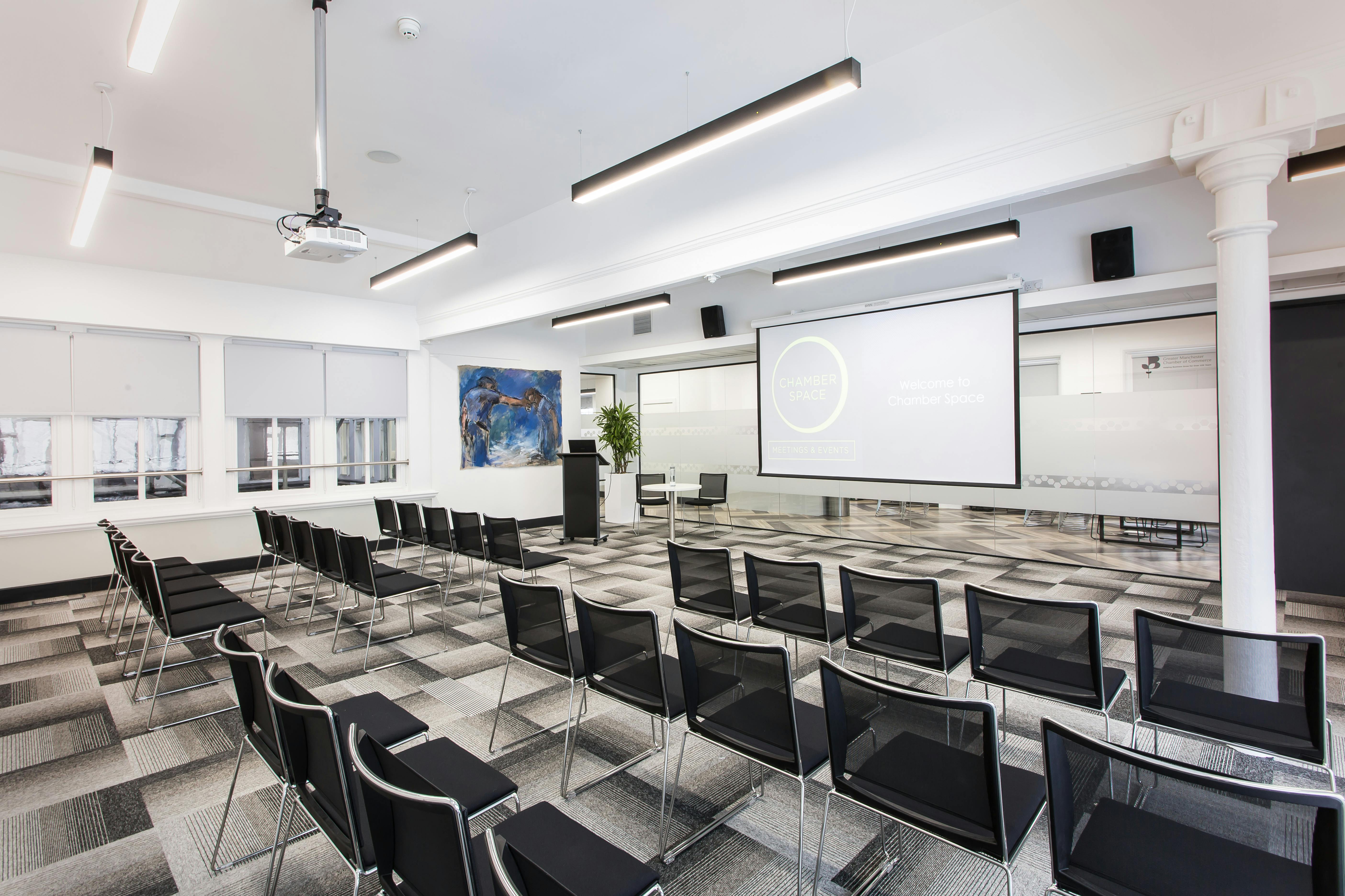 Elliot Suite A: modern meeting space with projection screen for events and presentations.