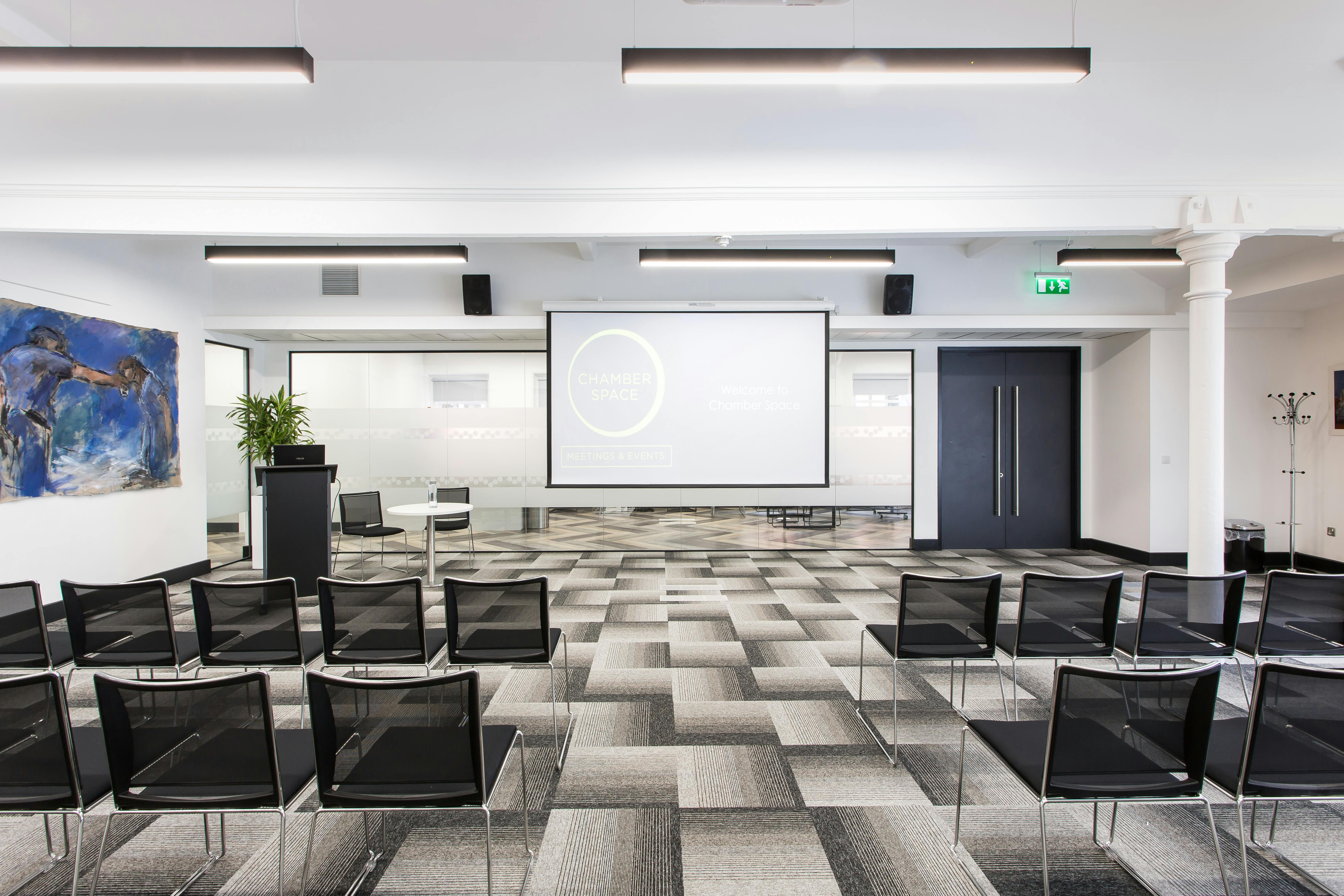 Modern event space with sleek chairs for corporate meetings and workshops.