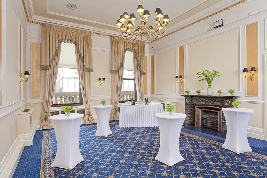 Elegant Trafalgar Rooms event space with chandelier, perfect for receptions and gatherings.