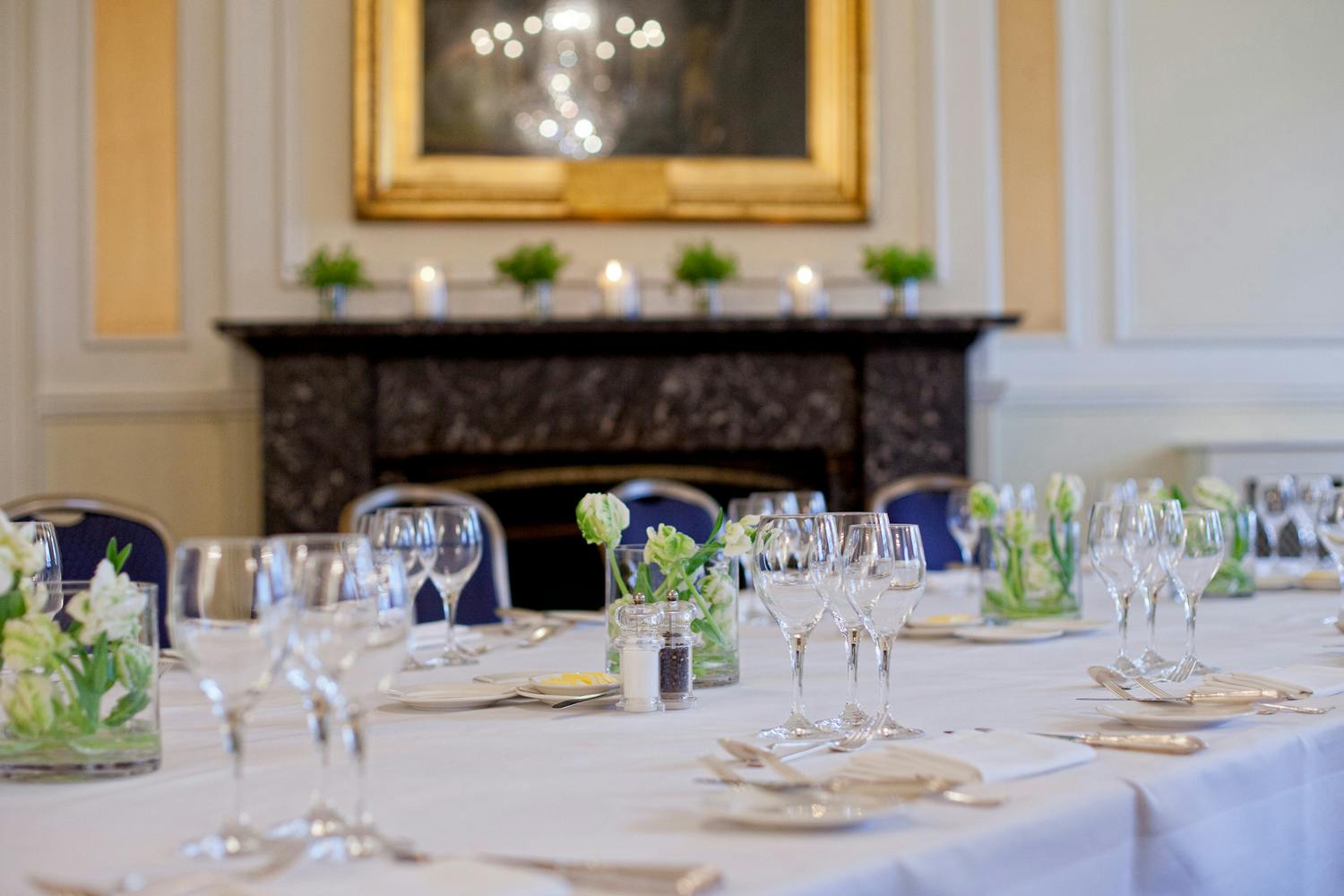 Elegant dining table with floral centerpieces at Trafalgar Rooms, perfect for formal events.