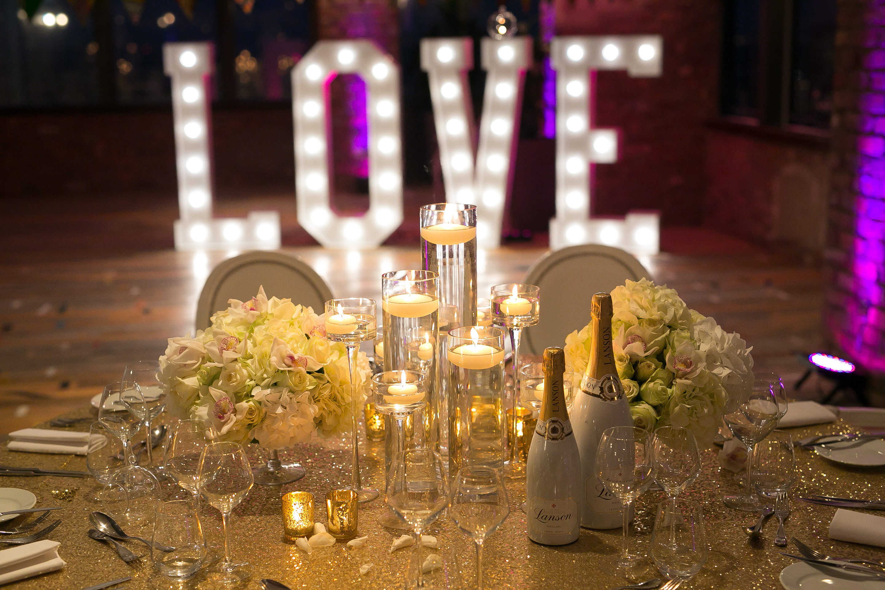 Elegant wedding setup at Skyloft - Westminster View with "LOVE" marquee lights. - Banner