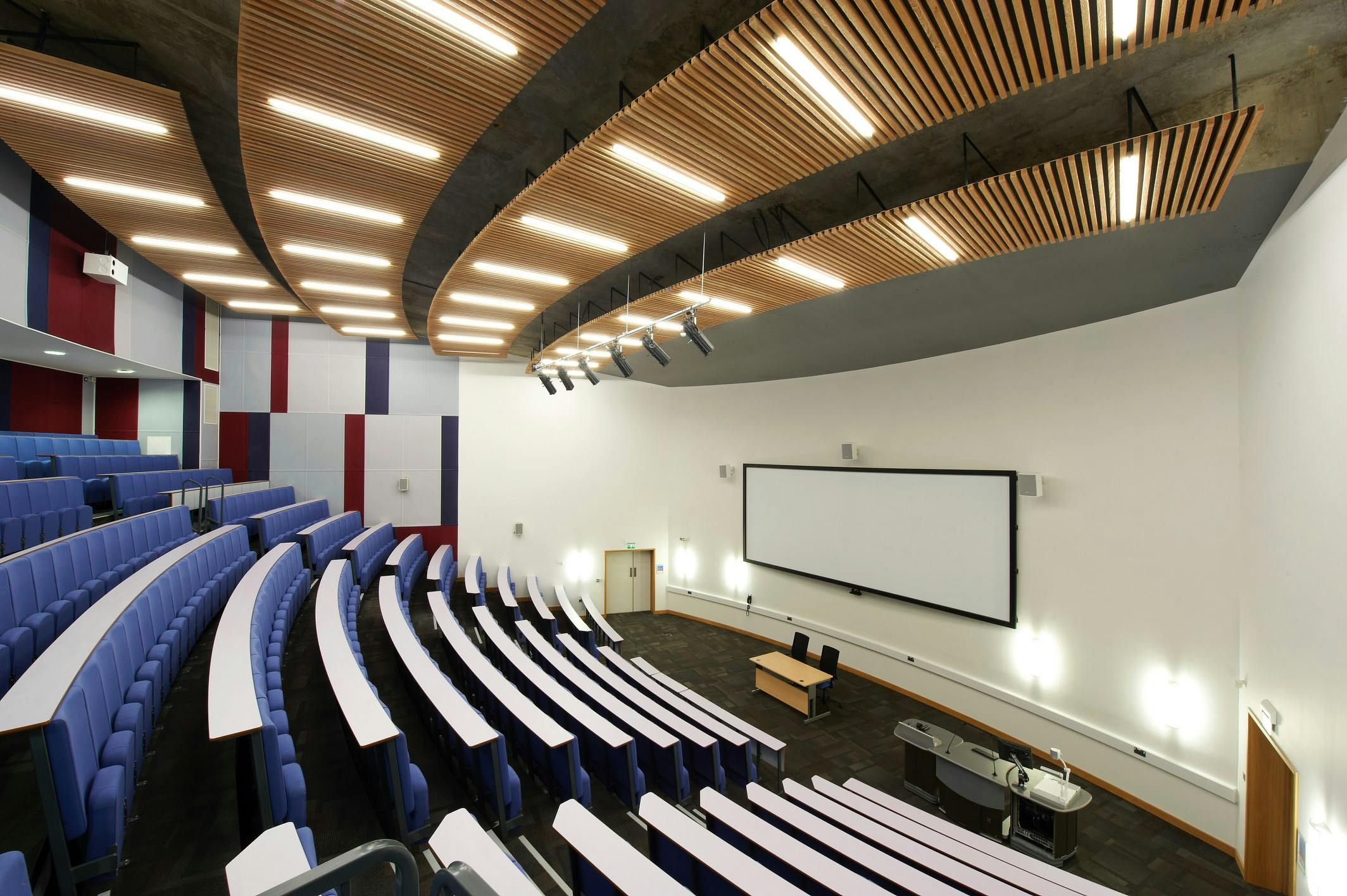 Modern auditorium with tiered seating for meetings and events at ARU Venue Hire, Cambridge.