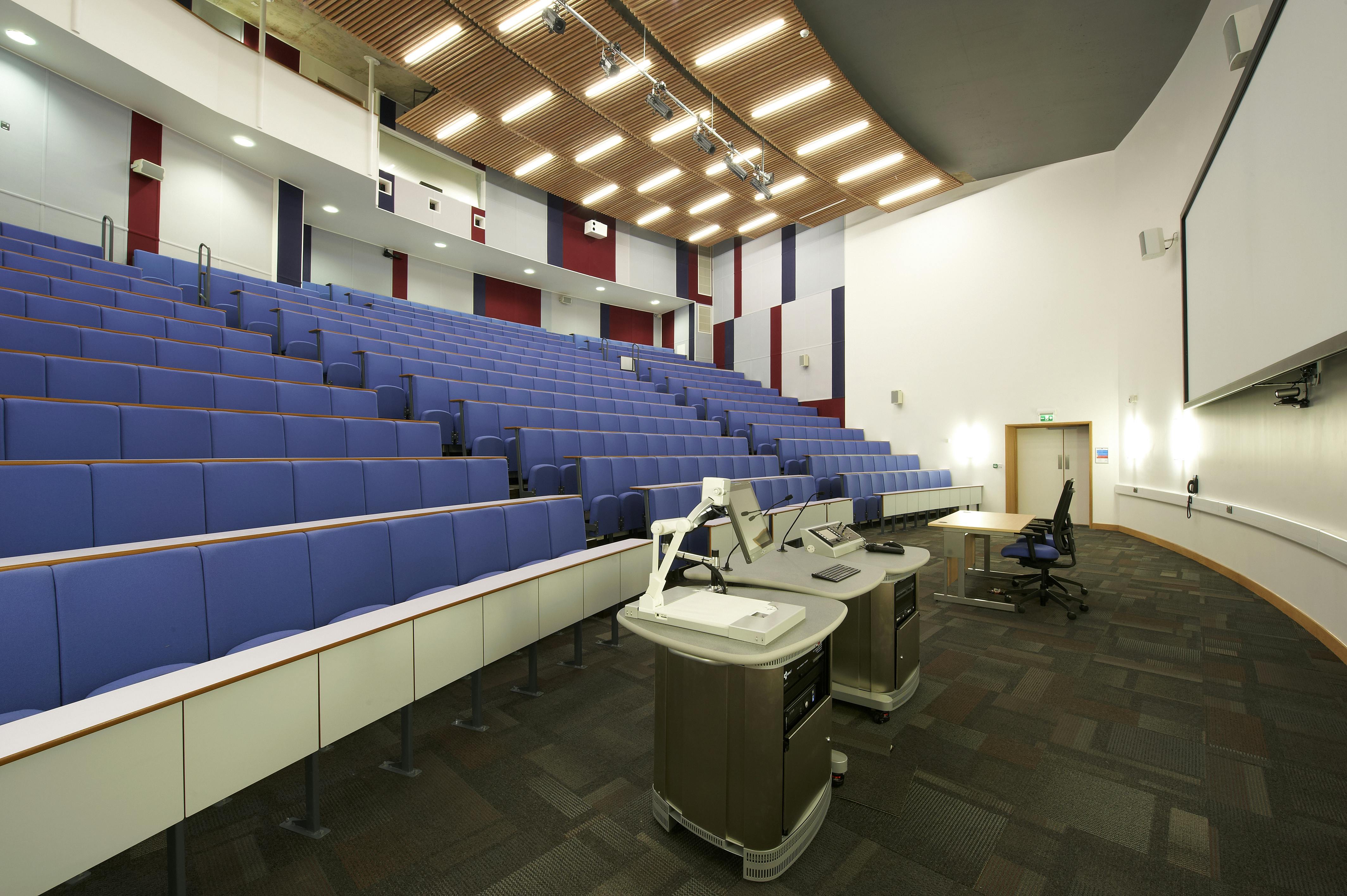 Modern lecture hall with tiered seating for conferences and educational events.