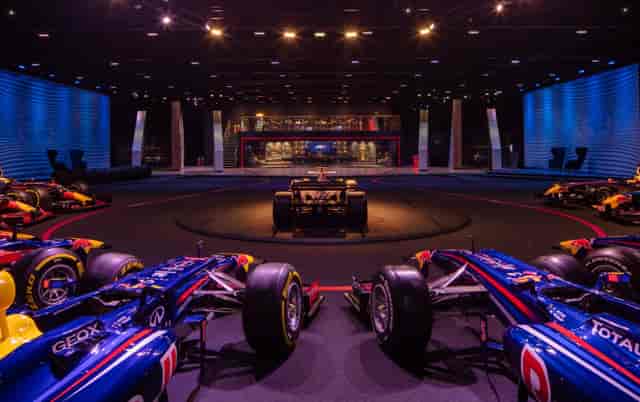 "MK-7 event space with Formula 1 cars for corporate gatherings and automotive launches."