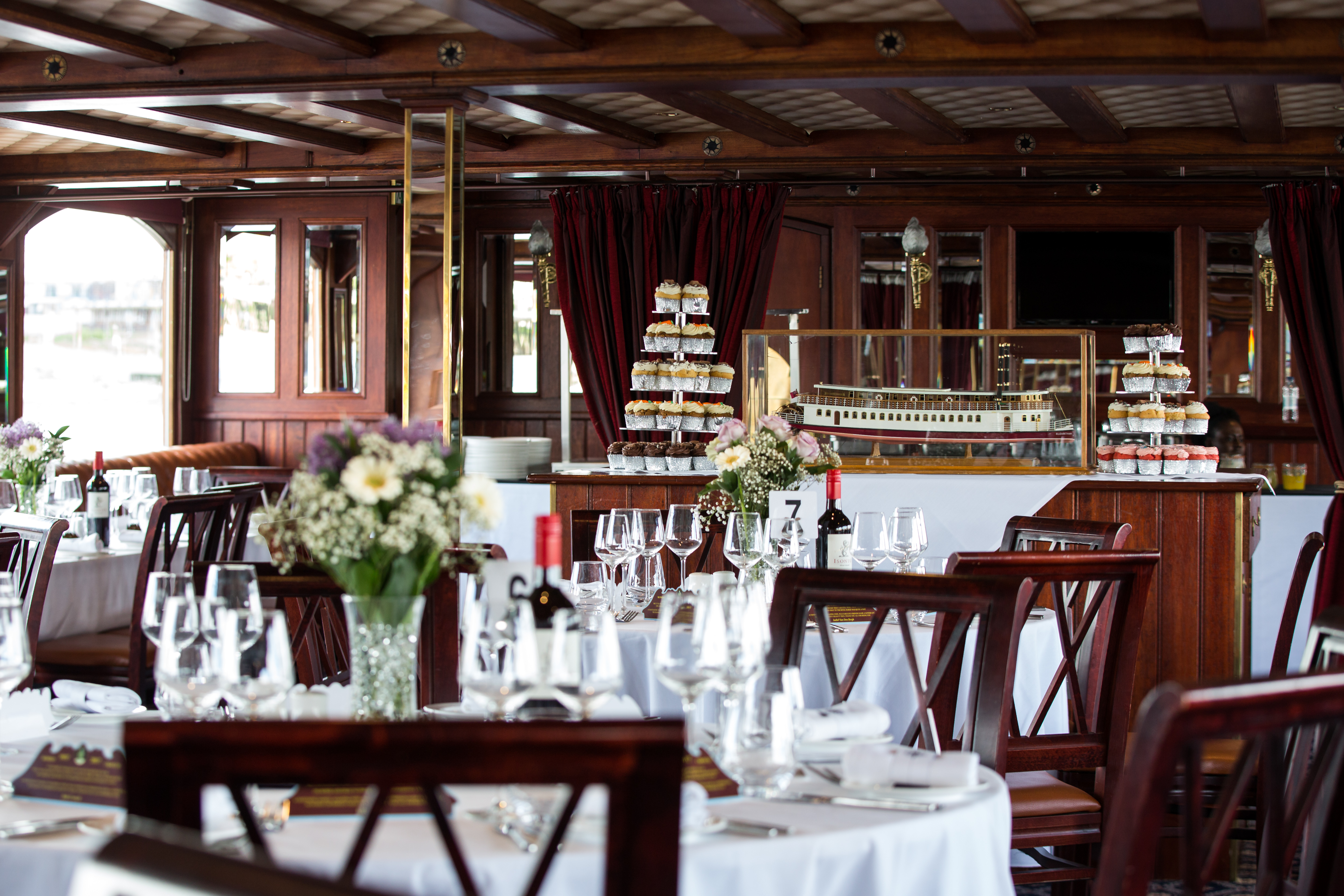 Elegant dining area on a boat, perfect for upscale events and corporate dinners. - Banner
