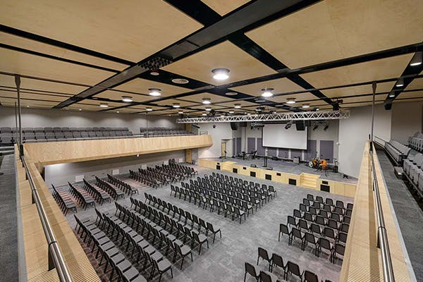 Spacious auditorium with tiered seating for conferences and concerts at City Gates Conference Centre.