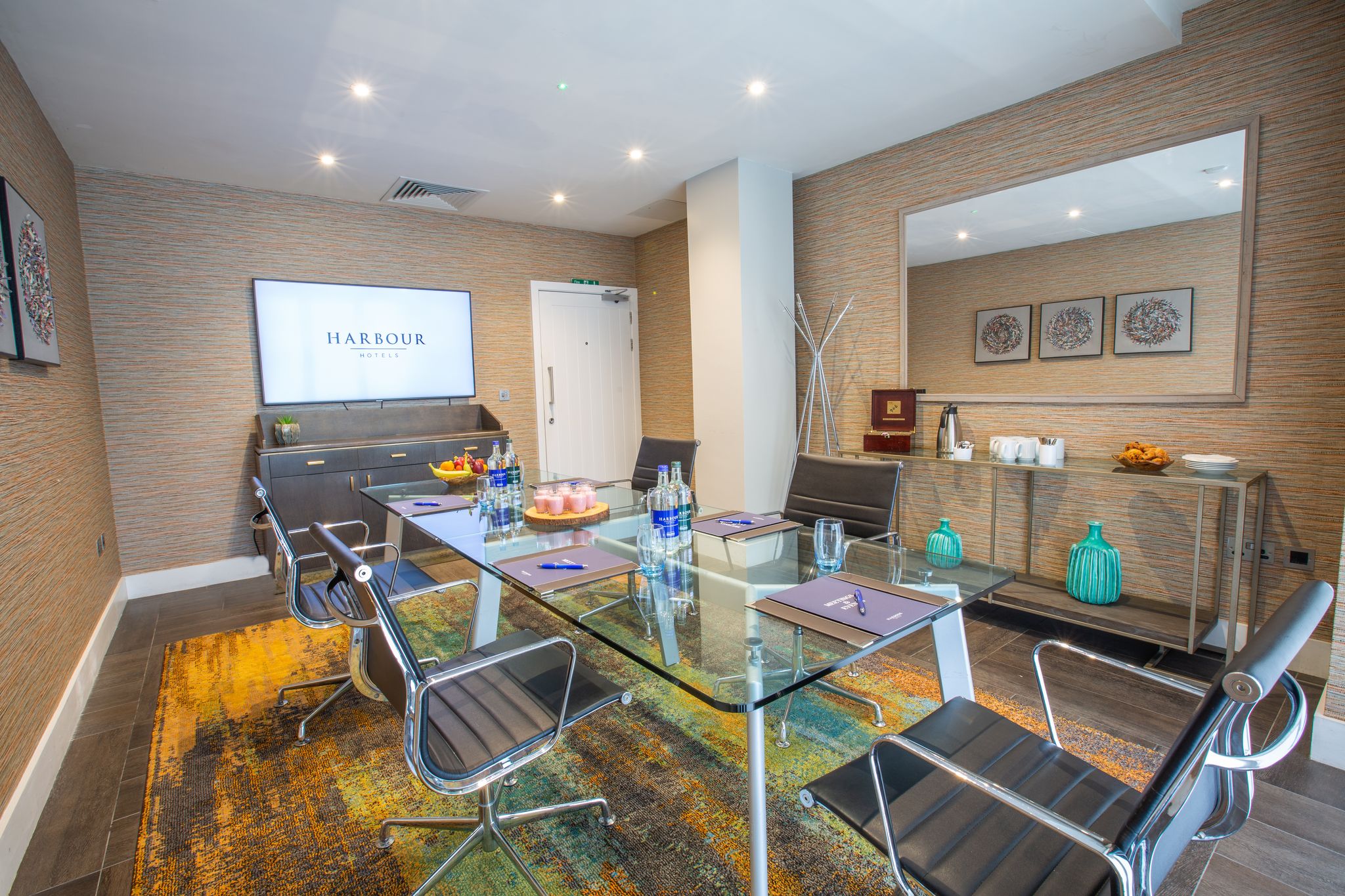 Modern meeting room in Guildford Harbour Hotel with glass table, ideal for conferences.
