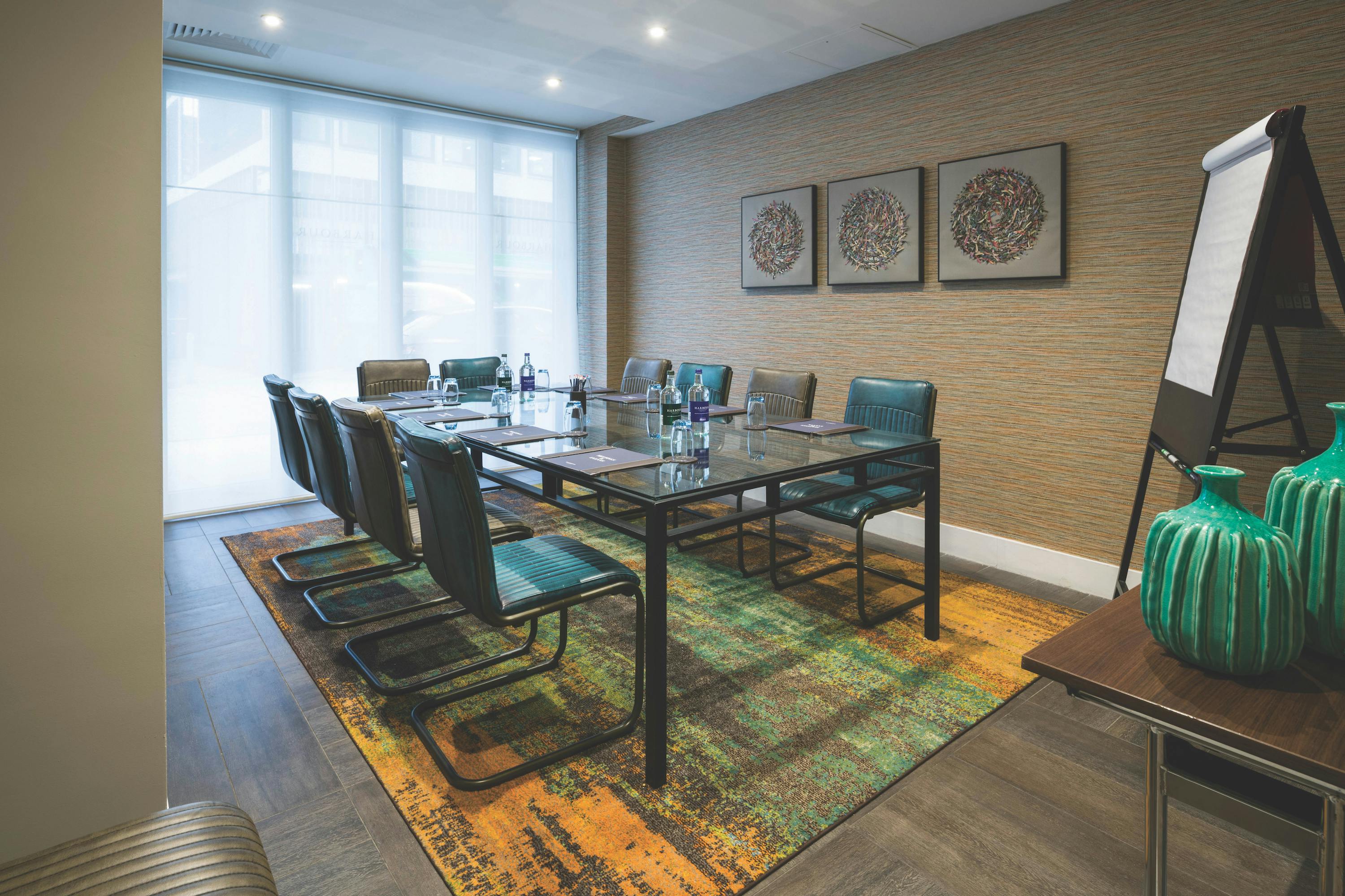 Harbour Suite 2 meeting room with glass table, ideal for workshops and conferences.