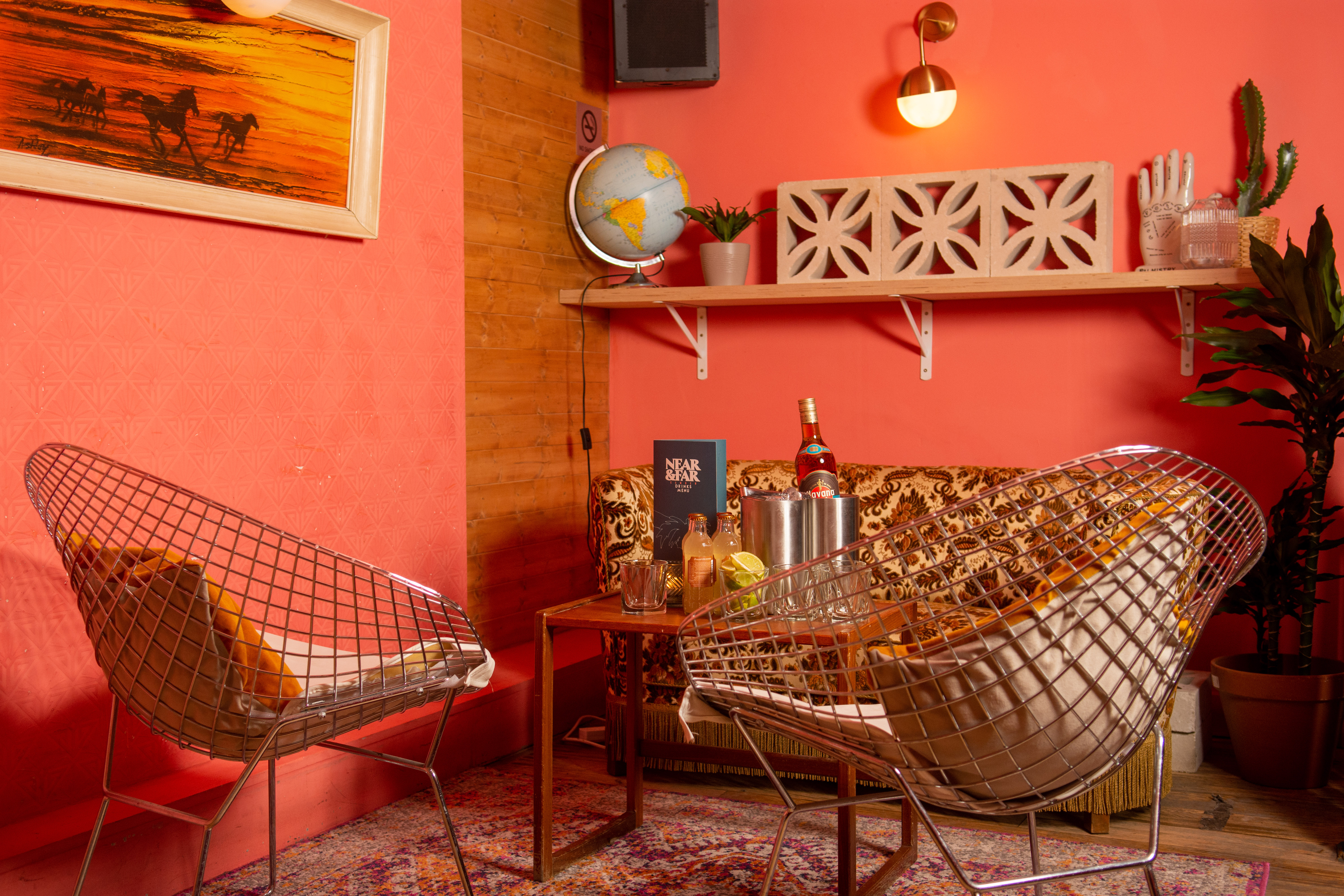 Stylish lounge in Studio 48 with coral walls, ideal for networking events and meetings. - Banner