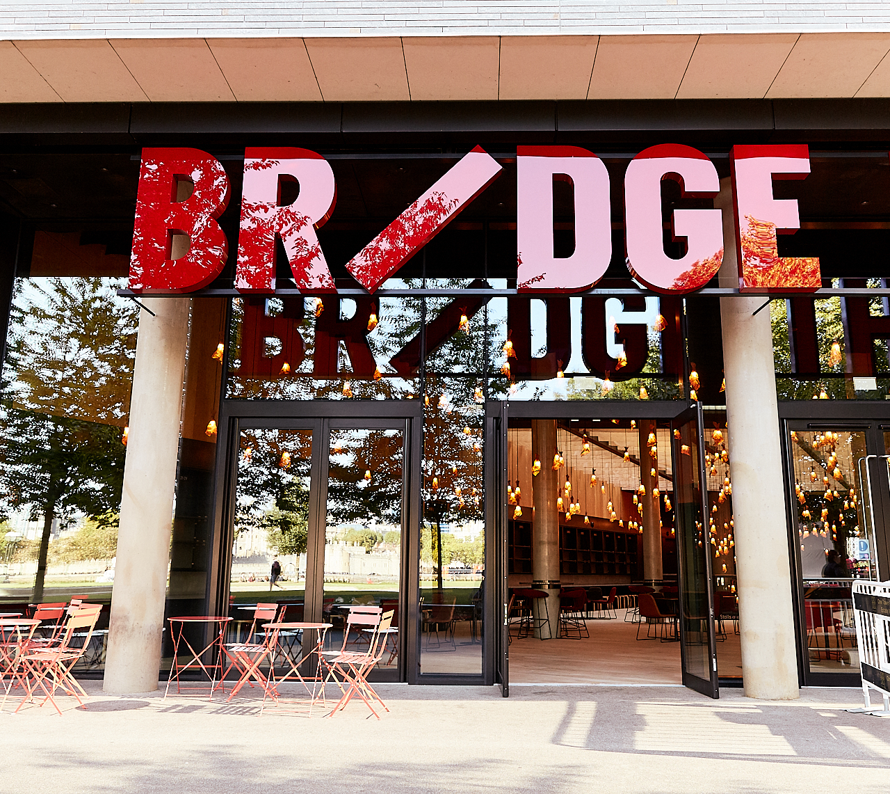 Modern Bridge Theatre auditorium entrance with bold signage, ideal for events and gatherings.