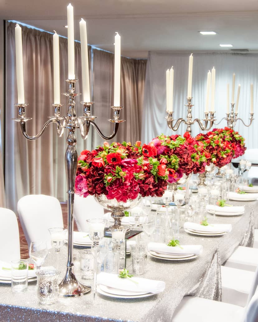 Elegant dining table with floral arrangements at Holiday Inn Whitechapel for formal events.