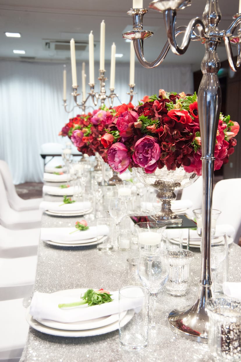 Elegant dining setup with floral centerpieces at Holiday Inn Whitechapel event space.