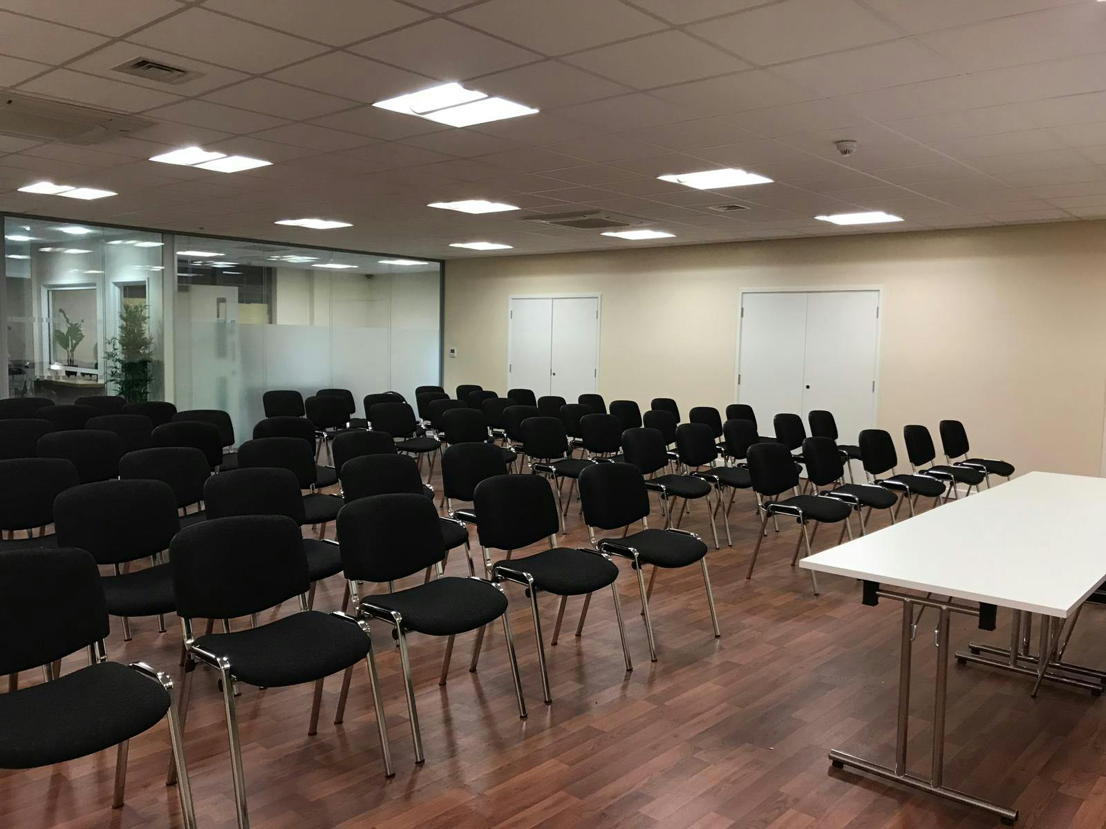 Conference hall with black chairs, ideal for professional presentations and workshops.