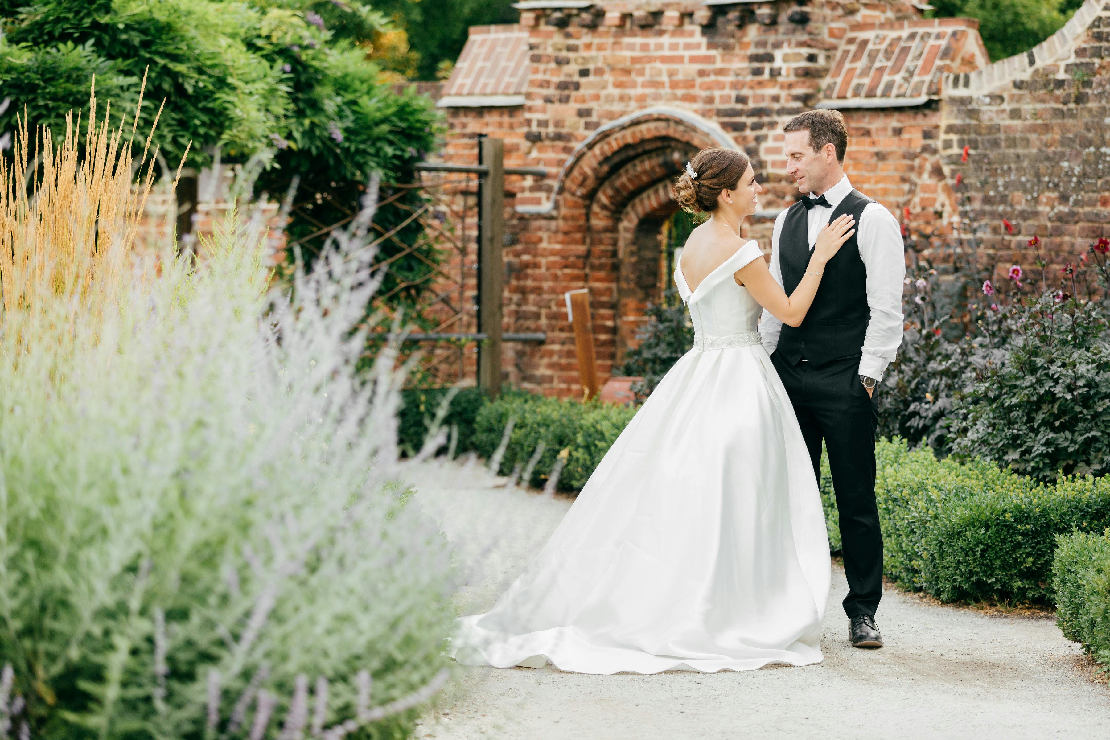 Styled couple in lush Walled Garden, Fulham Palace - perfect for romantic weddings.