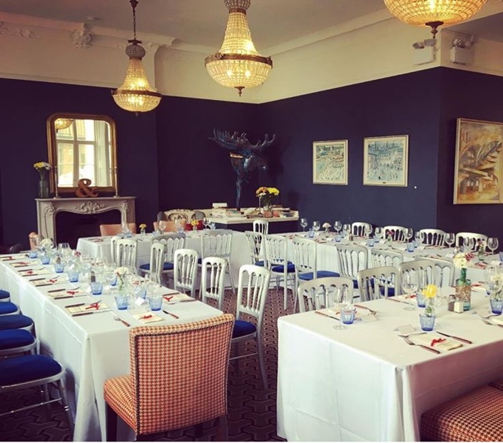 Elegant Lillie Lounge event space with floral centerpieces, ideal for gatherings and meetings. - Banner