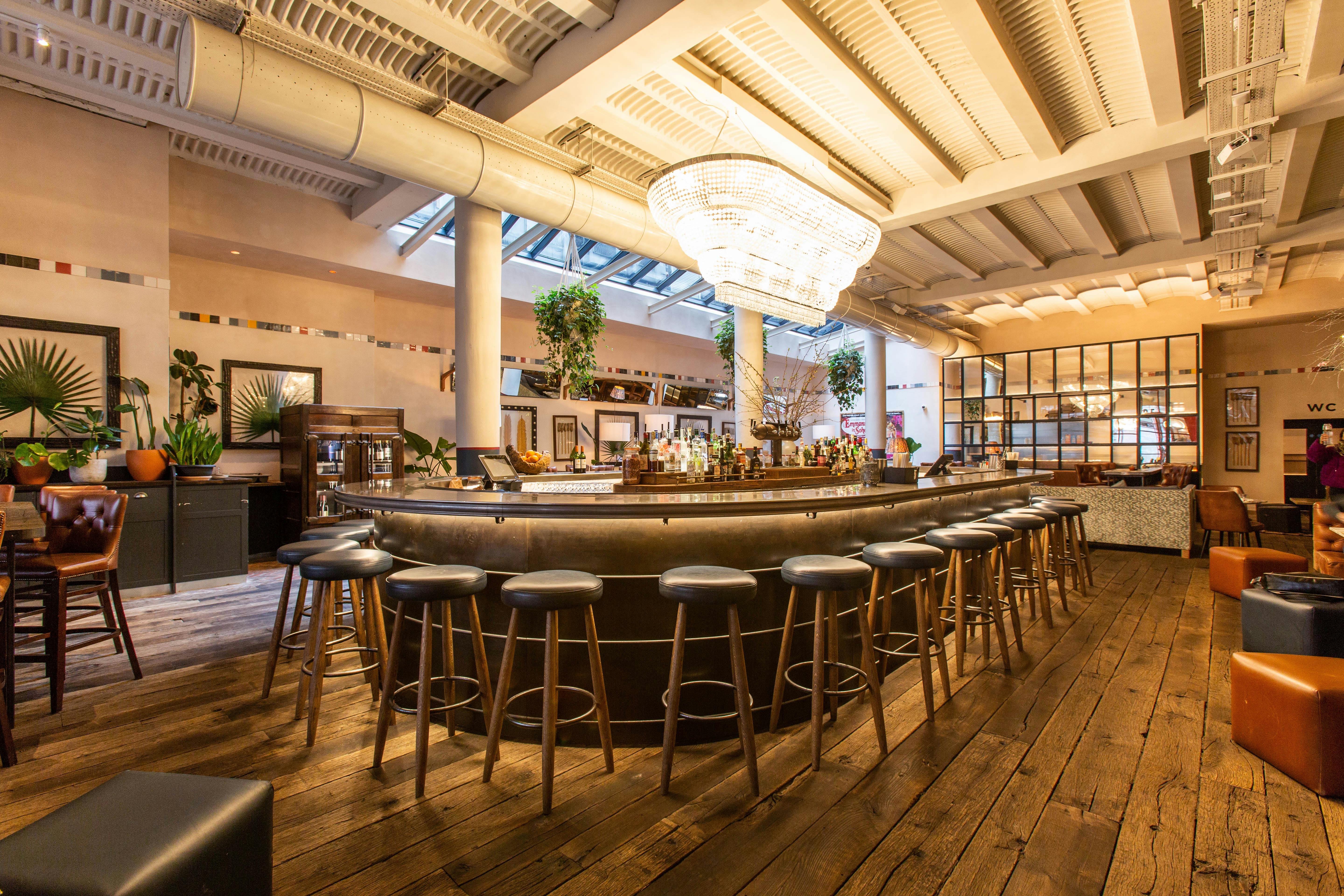 Stylish bar at Sophie's Soho with natural light, ideal for networking events and gatherings.