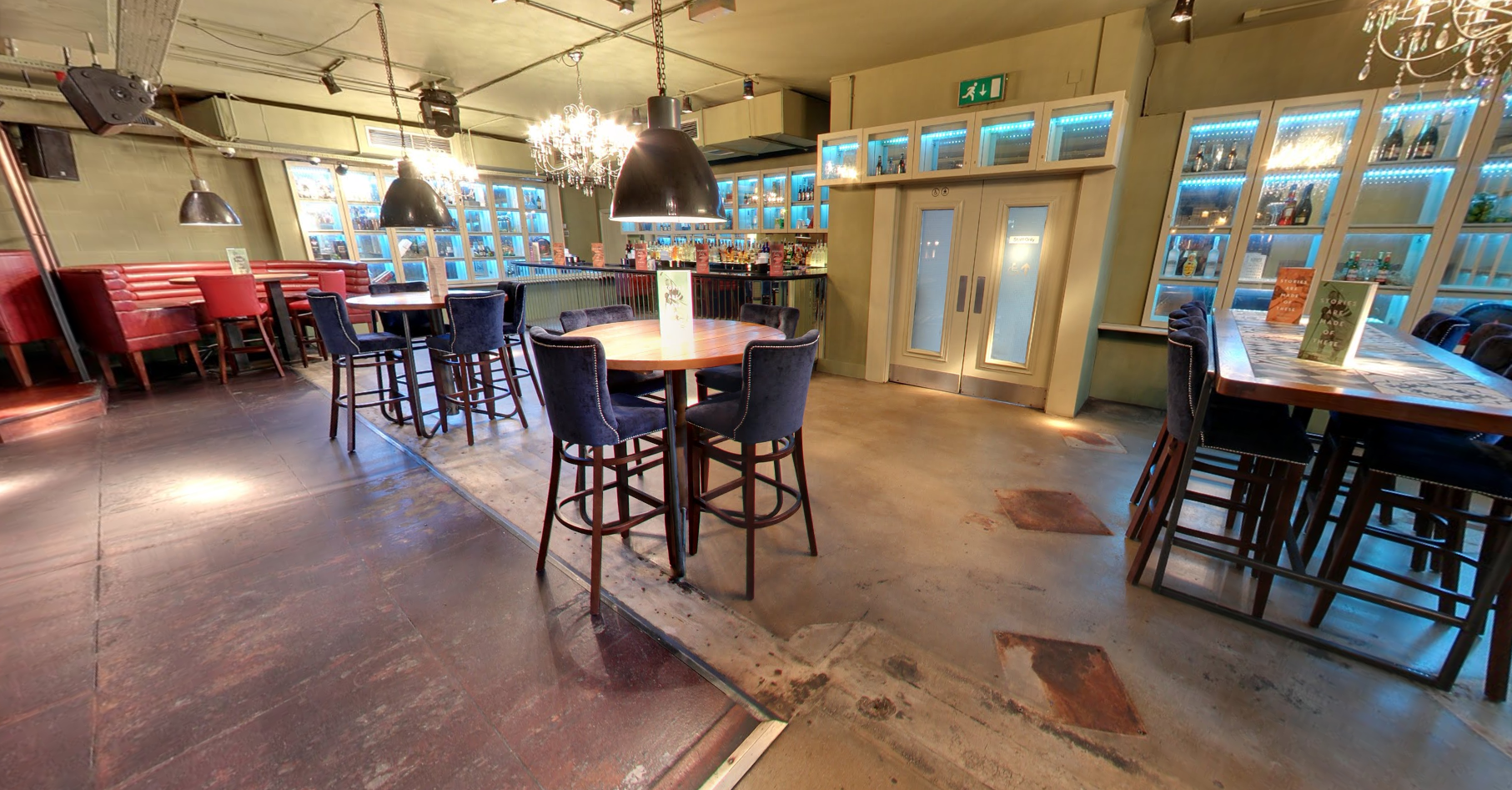 Modern event space in Revolution Plymouth with high-top tables for networking gatherings.