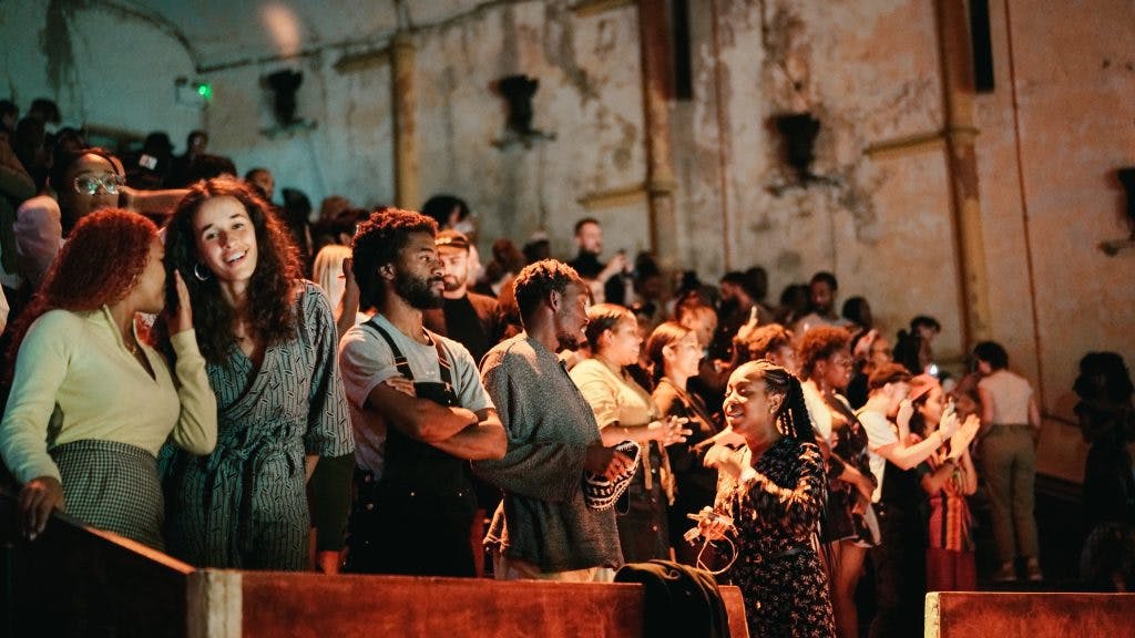 Vibrant crowd at EartH Theatre, showcasing inclusivity and dynamic event atmosphere.