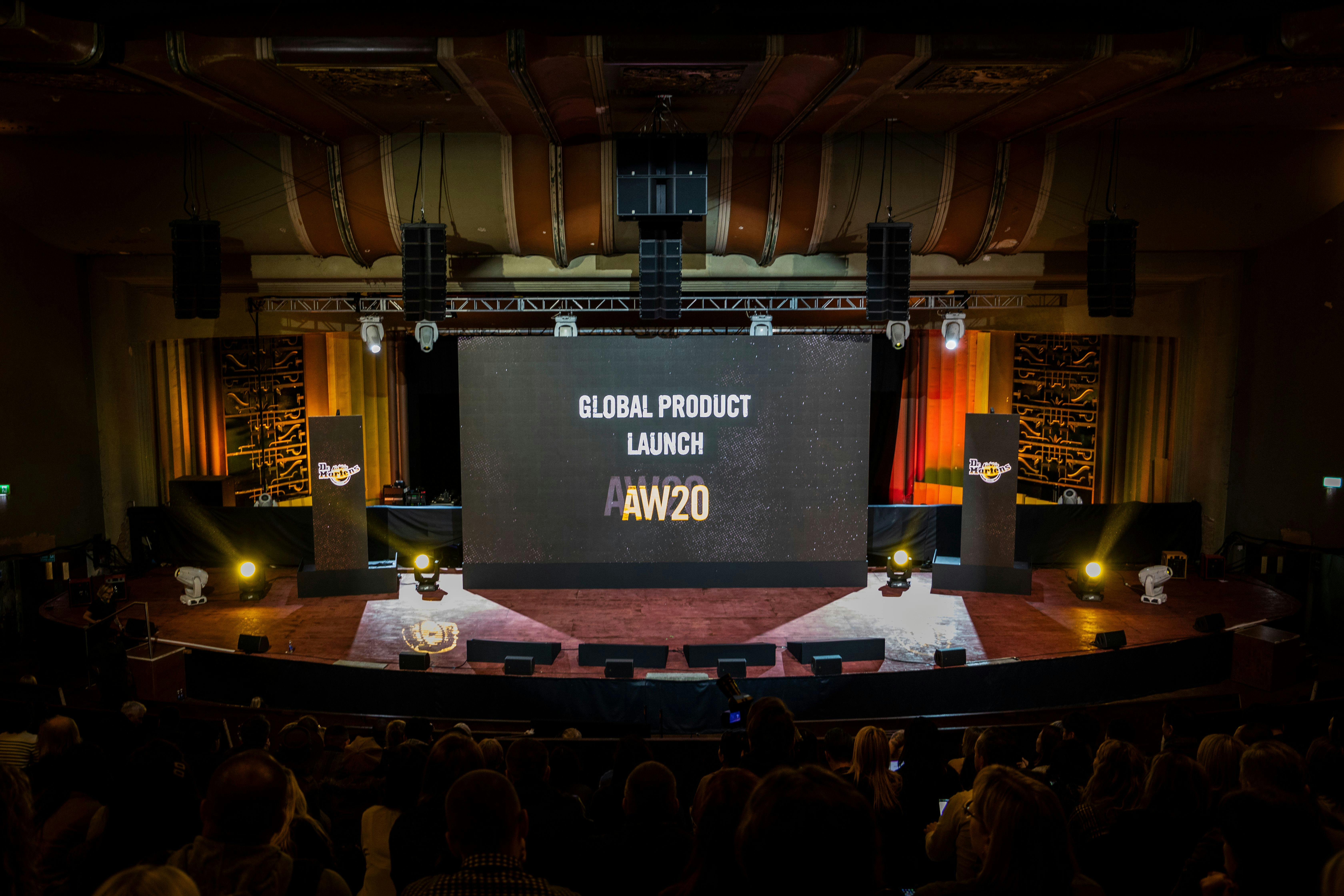 Theatre in EartH set for global product launch with elegant lighting and seating.