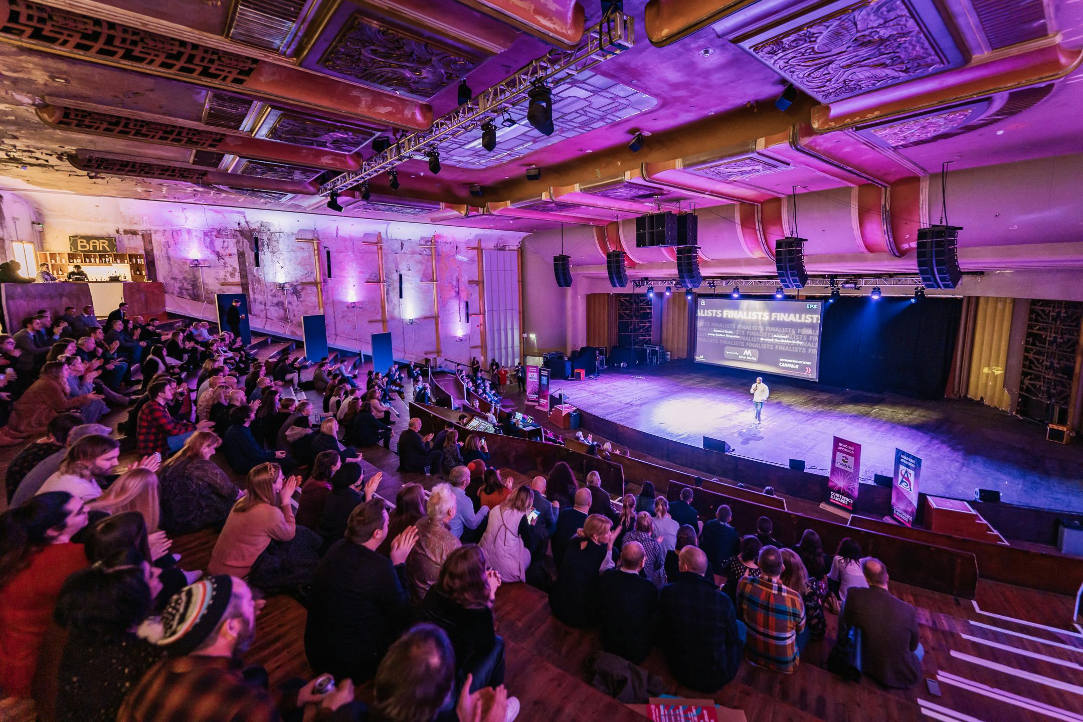 Vibrant Theatre in EartH with engaged audience, ideal for networking events.