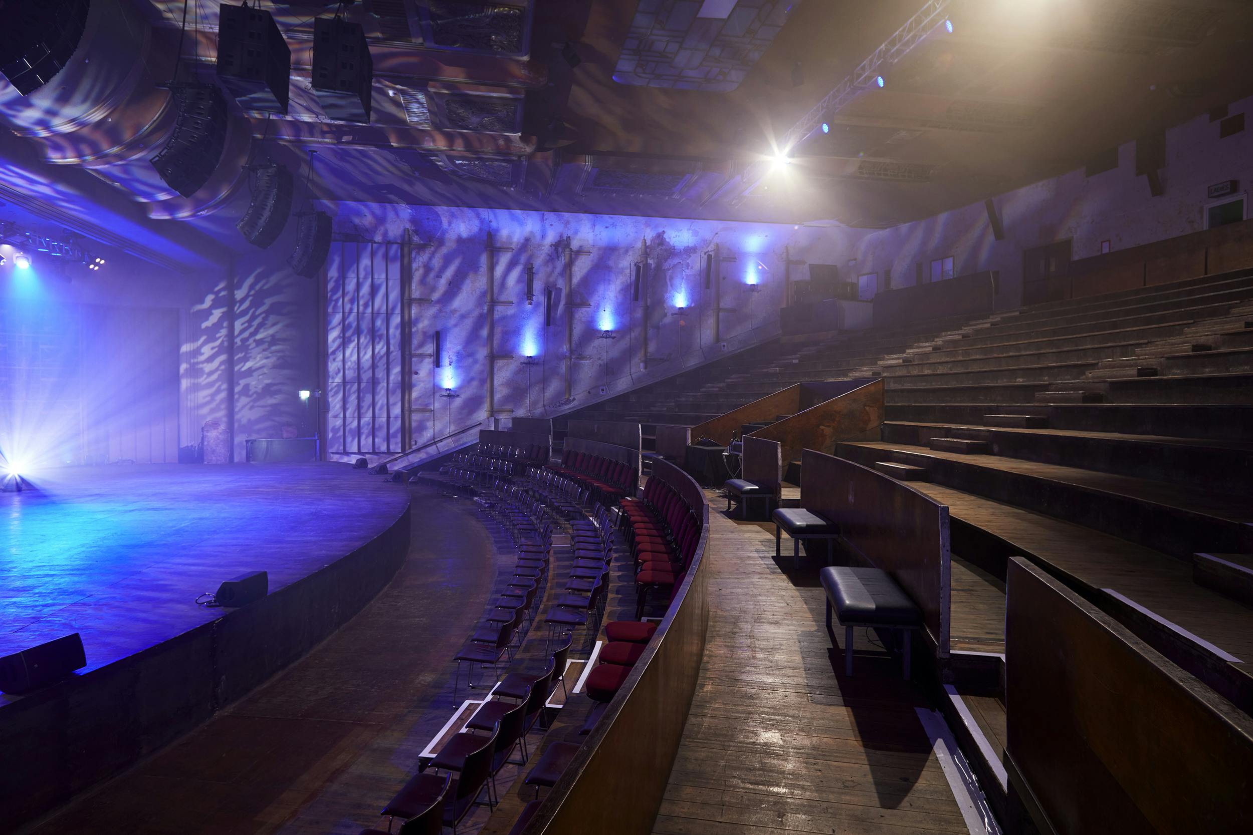 Spacious EartH theatre with tiered seating, ideal for corporate events and performances.