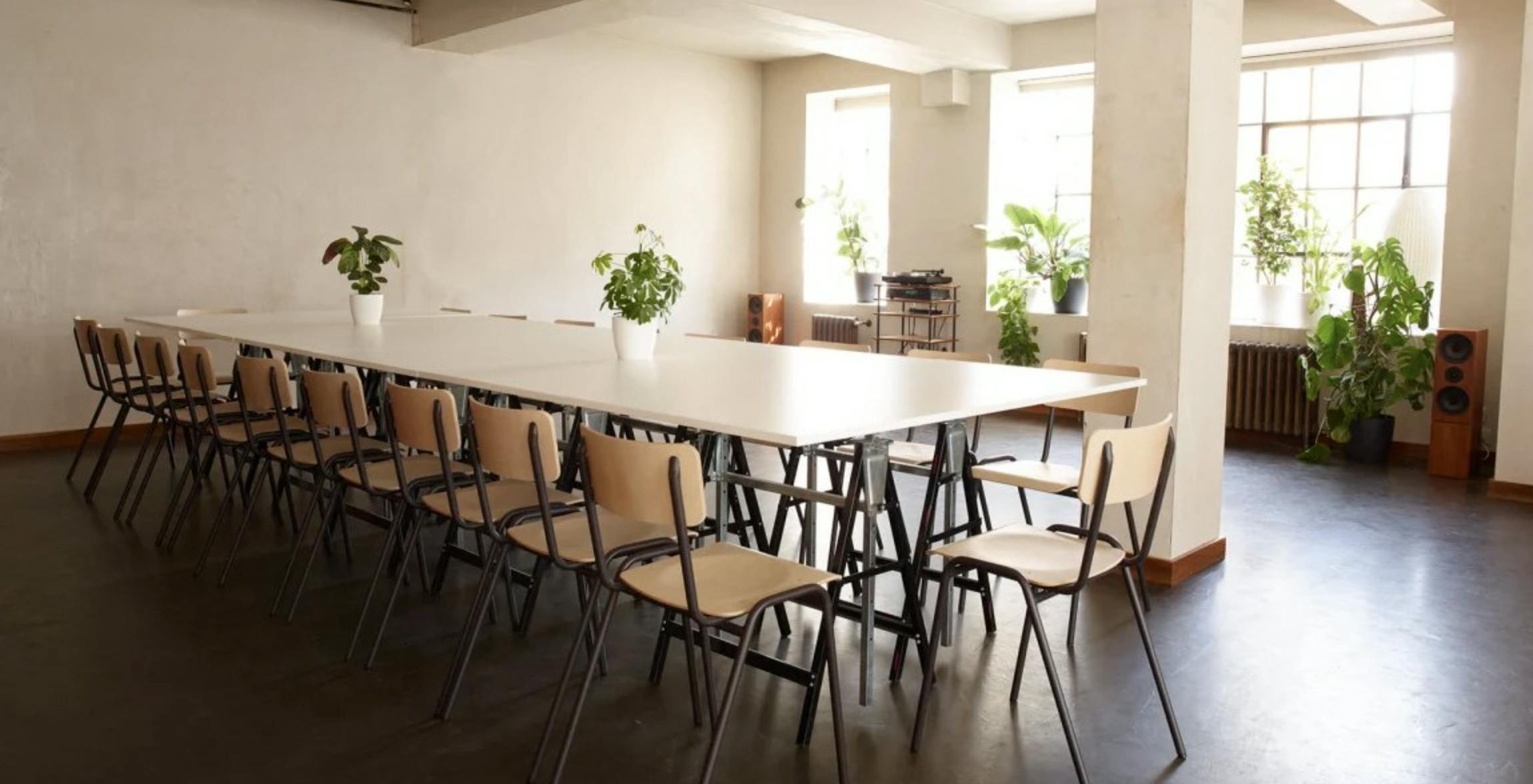 Spacious meeting room with long table, ideal for seminars and workshops at Robert's Place Studios.