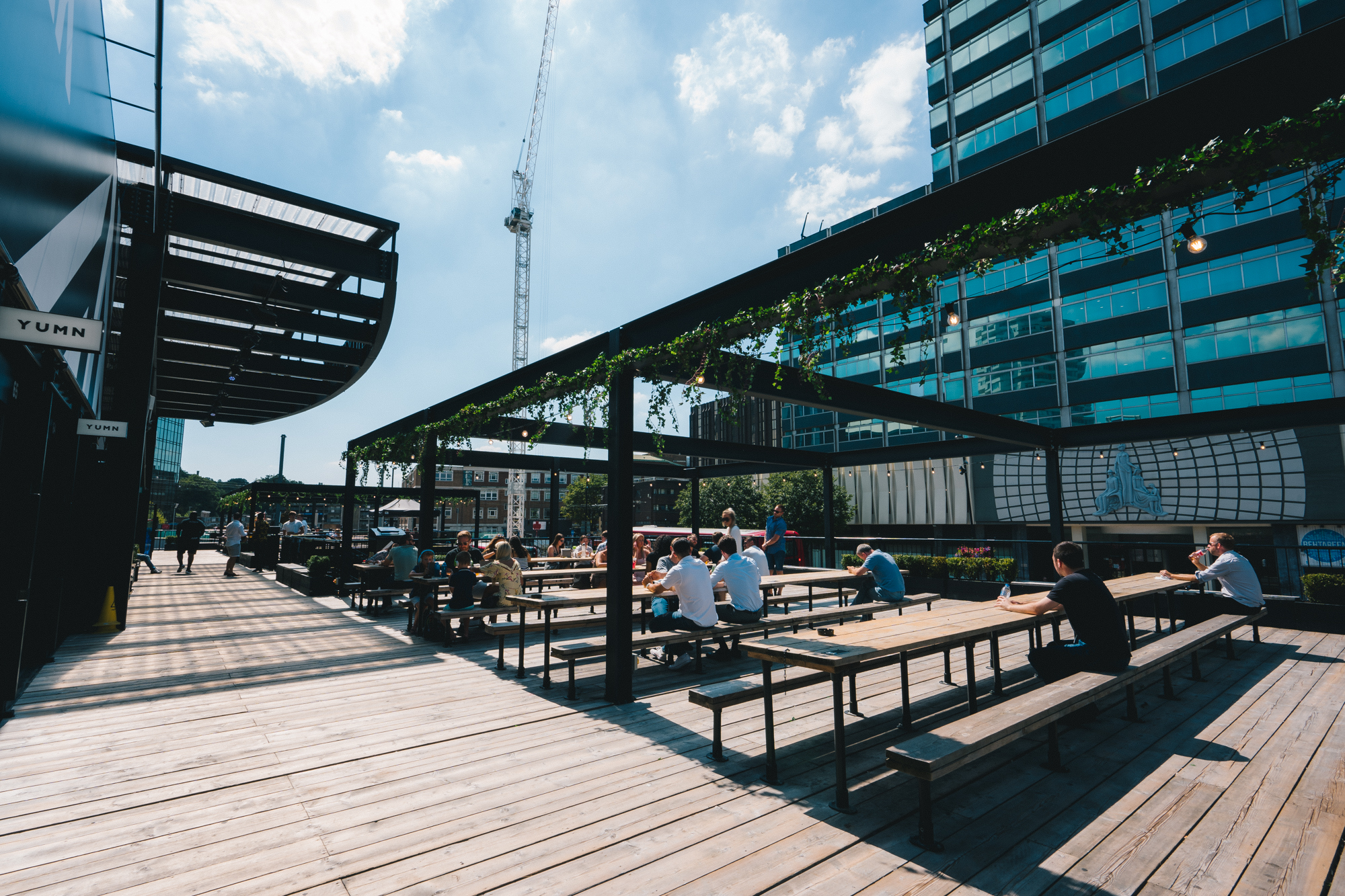 Vibrant outdoor event space with seating at Boxpark Croydon for summer gatherings.