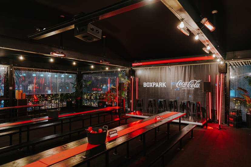 Vibrant Boxpark Croydon terrace with communal tables for networking events.