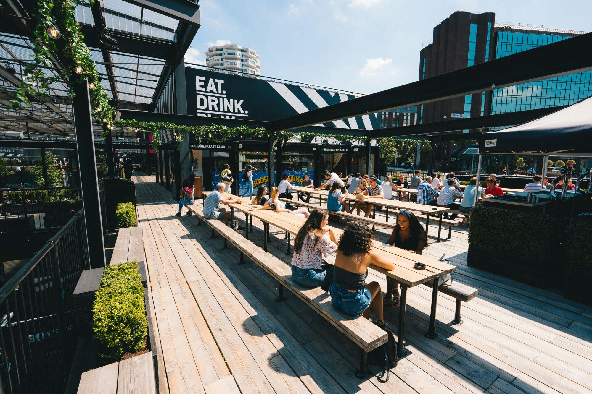 Vibrant outdoor terraces at Boxpark Croydon, ideal for summer events and gatherings.