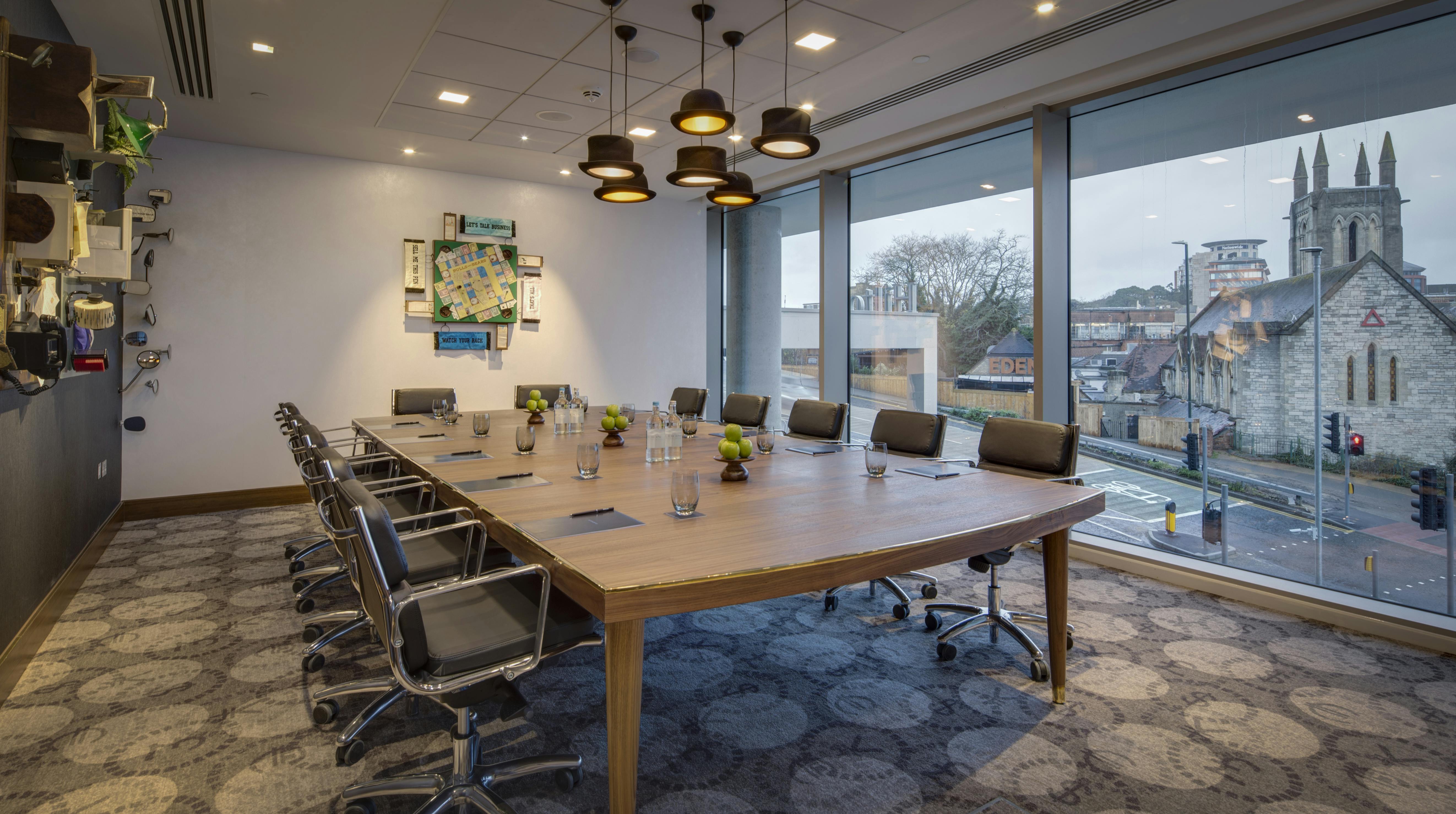 Modern conference room with oval table at Bulls & Bears, ideal for meetings and presentations.