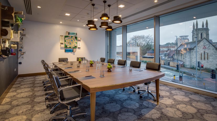 Modern conference room with oval table at Bulls & Bears, ideal for meetings and presentations.
